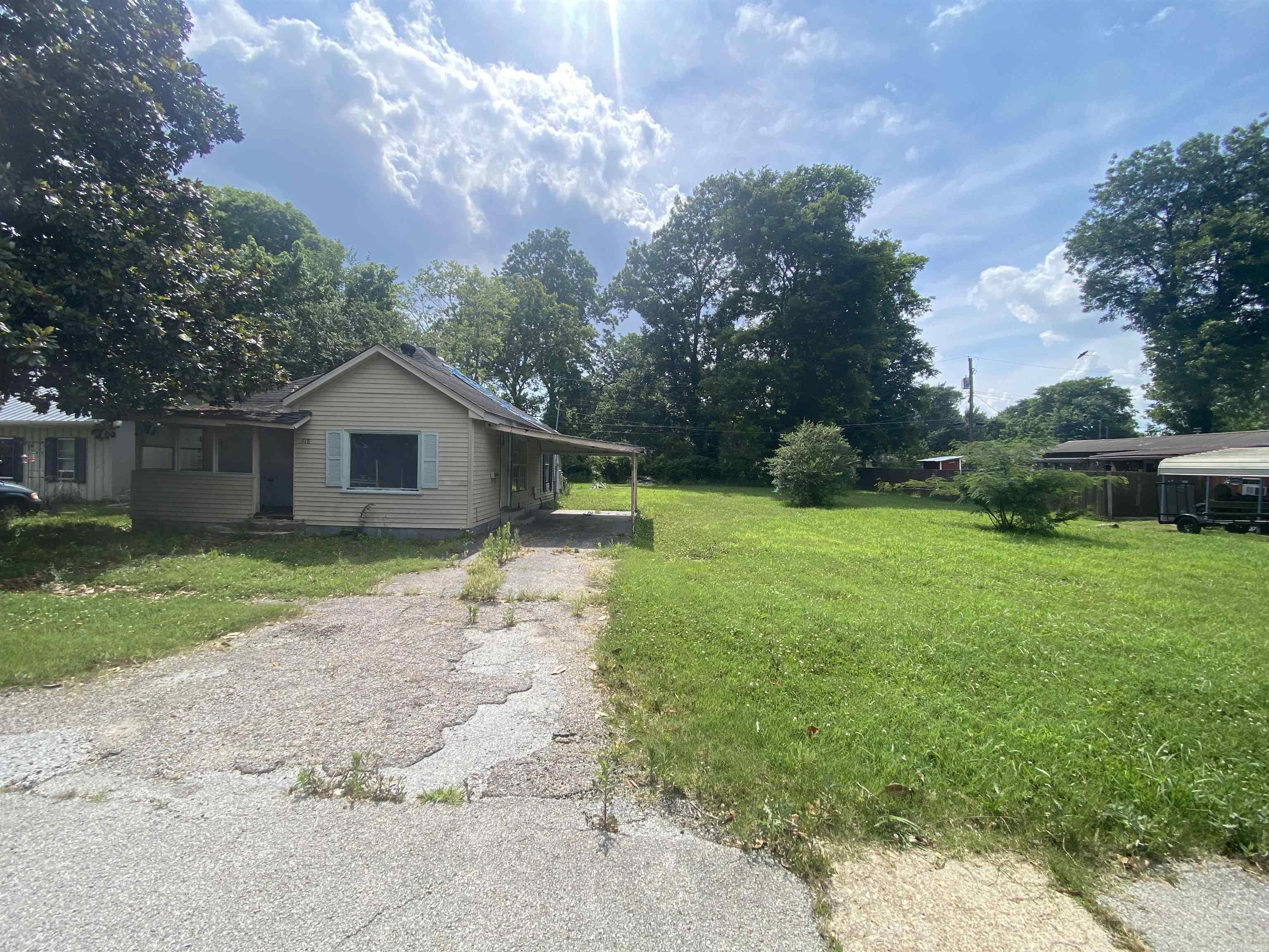 2 R-2 lots which each measure about 55x120, and together about 110x120. There is a dilapidated house on the property, do not enter. The asking price reflects the worth of the 2 lots. Check with the city of Trumann concerning building measurements, but one should be able to build a duplex or two single family homes, after removal of old house.