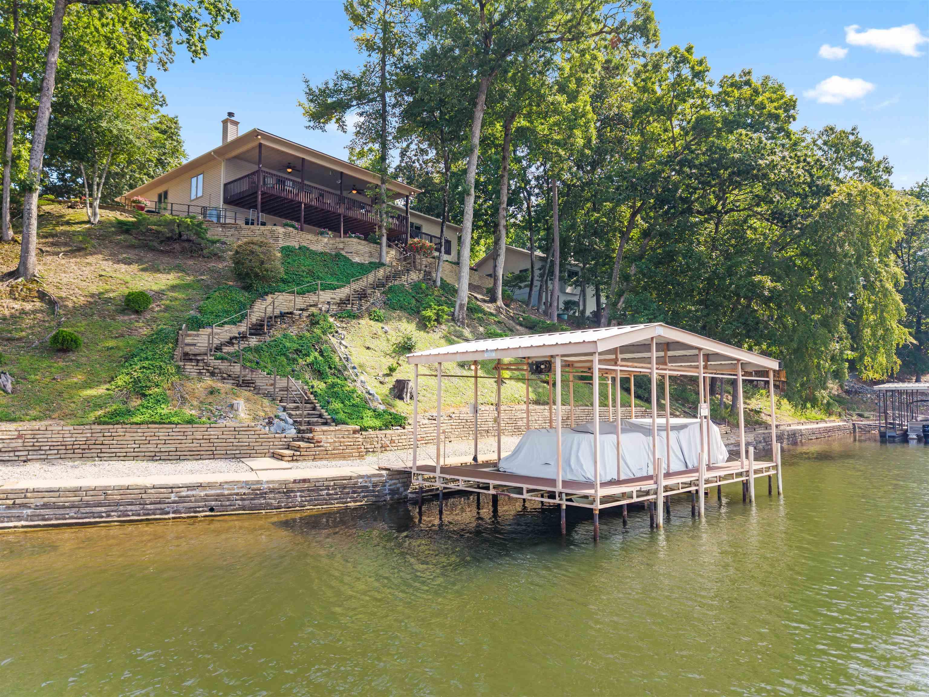 126' of PANORAMIC WATERFRONT! This meticulously maintained Lake Balboa home boasts views in every direction! New Roof 2025, Lifetime Transferrable Warranty on Leaf Guard gutter covers, HVAC is less than 3 years old! Enjoy the beautiful Engineered Hardwood Flooring, Propane Corner Fireplace, and Spacious Dining Room perfect for holidays! The Bright Kitchen with Eating Nook provides a 2nd access to the Entertainment-sized Covered Deck with Ceiling Fans and Panoramic Views! In addition to the Den/4th Bedroom off the Entry, there is an oversized Guest Room and Full Guest Bath with Walk-in Shower! The Master Bedroom has Windows looking onto the Lake, a large Walk-In Closet, and Dual Vanity Bathroom  with Jetted Tub! The Lower Level features a Rec Room with Walkout to the Rear, but also a separate area with Murphy Bed and Deep Walk-in Closet (great for Guests and/or 4th Bedroom! An additional Storage Room (not included in the square footage - buyer to verify - makes a great Storm Room or extra storage area! Gorgeous Oversized Stone Steps and a Commercial Quality Metal Handrail lead down to the Covered Boat Dock with Lift! Seawall & Landscaping walls are gorgeous! Tandem depth 2Car Garage