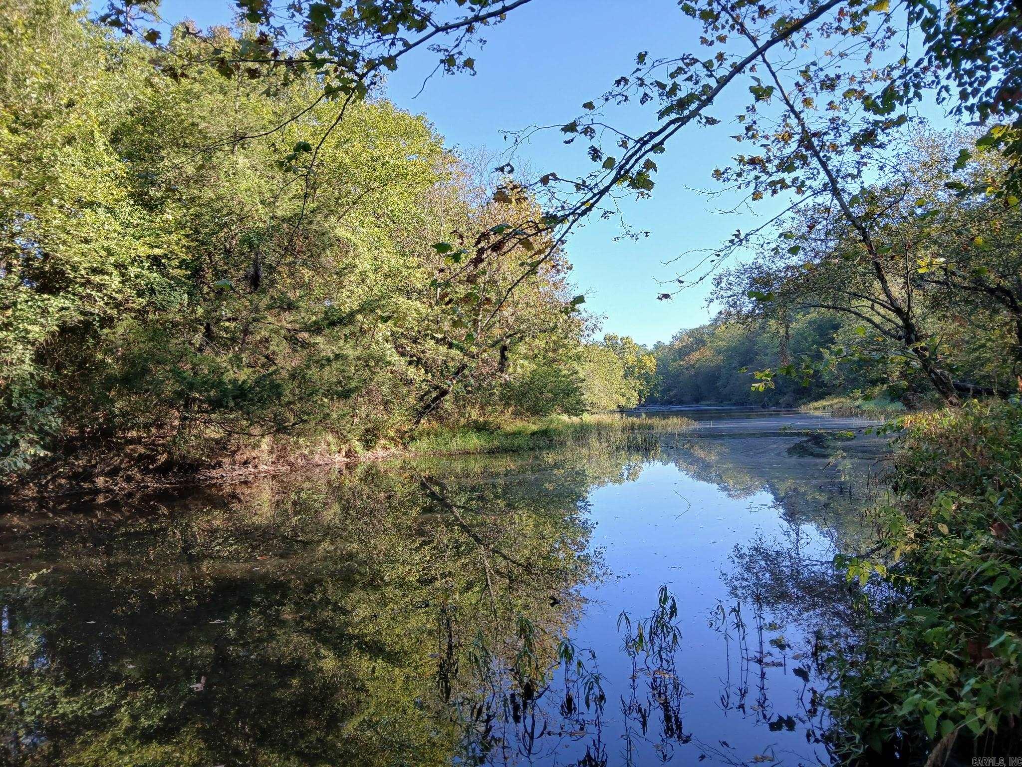 Want river frontage? We got it!! Beautifull wooded acreage located on the Irons Fork River in Ink, not far from the Mena city limits! 10 acres of wooded property, perfect for building spots with lots of privacy. This kind of property doesn't come along very often! Property will need to be surveyed off from the main parcel. Some restrictions apply. Also, owner is offering a 2500 sf mobile home for sale for an additional $45,000. Mobile home is 4 bedrooms, 3 baths, and has a new metal roof, massive kitchen with tons of counter and cabinet space, office, dining room, great room, entry, utility room, all appliances included. Custom built, 6 inch walls, solid plywood subfloors. Mobile home would have to be moved onto the property from an adjacent property. Agents see remarks.