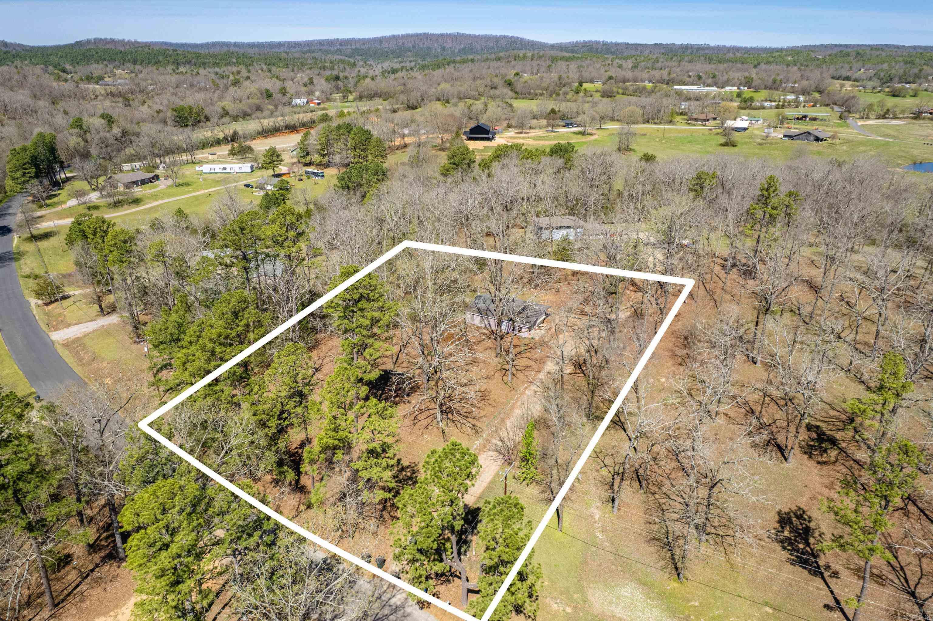 This property boasts a fixer upper or a potential home place for you to build your dream home in the Lake Hamilton School District! Don't miss out! This beautiful, wooded property has a lot to offer.  It is convenient but private and has city water! Come check it out!