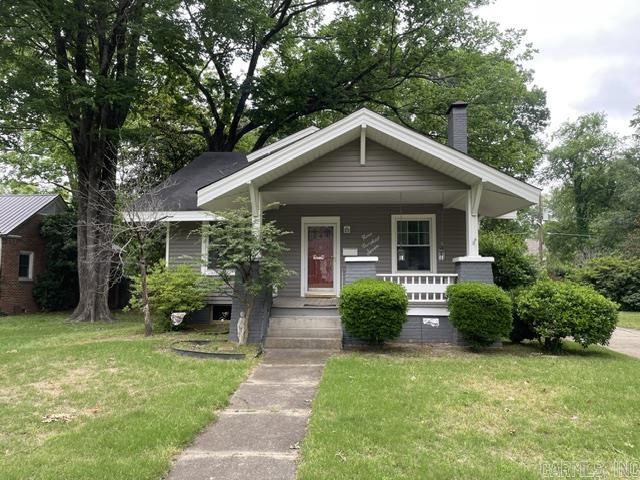 Great craftsman style house with a quaint front porch.  It has driveway from front to back, with a carport for 2 cars detached in back next to storage building .  Also has a sitting area off the back entrance.  Inside top floor, contains a full bath, and 2 bedrooms.  Middle floor has living space, dining area, full bath, bedrooom with sitting area, kitchen all ready for you and your family.  The basement is unfinished with laundry area, water heater, and sump pump.