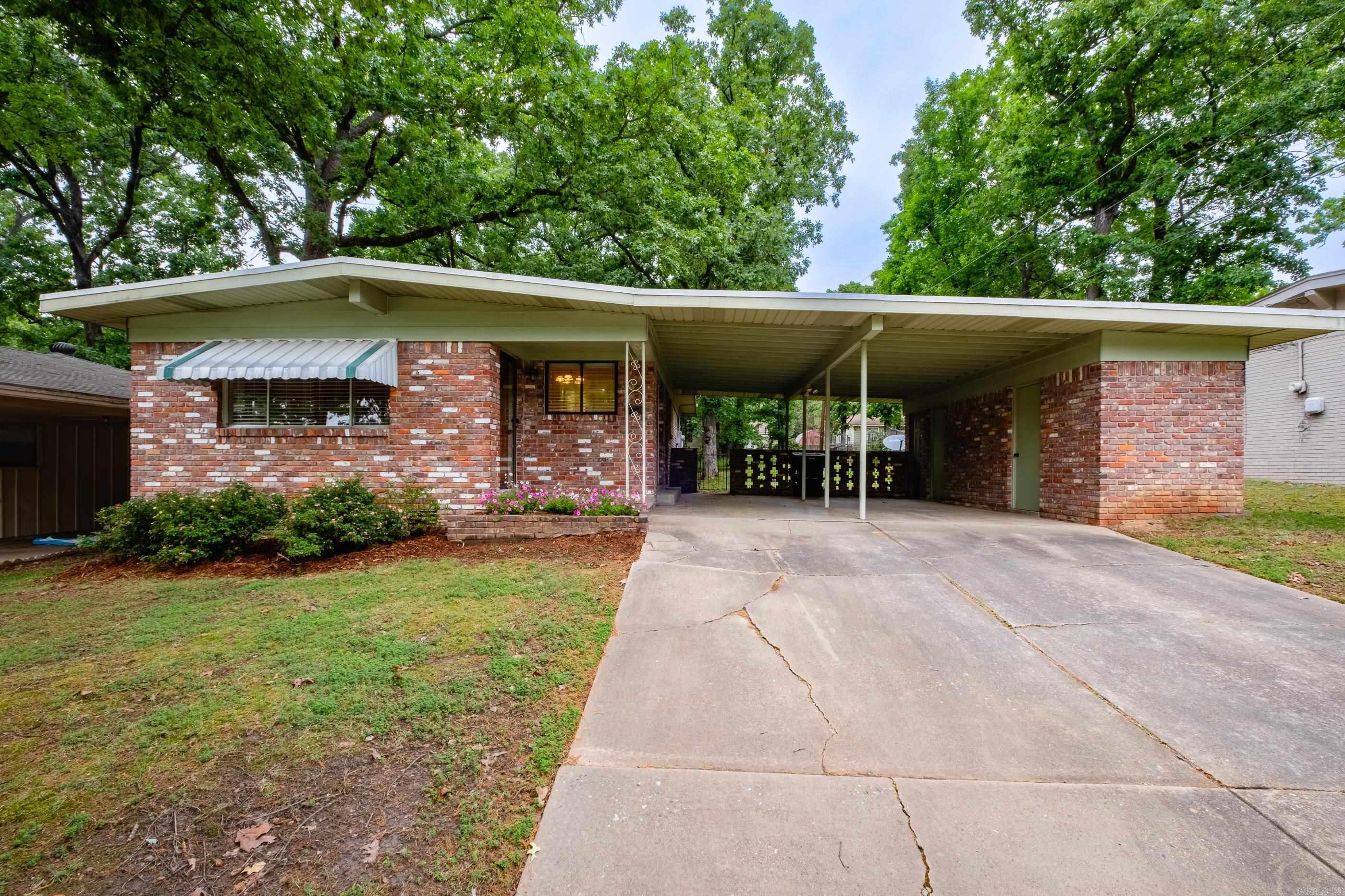 If you're looking for something centrally located with gorgeous hardwood floors and updated...this is it! Enjoy all the light throughout this mid-century modern, large back deck and fully fenced back yard, two car carport with tons of storage! Third bedroom was converted to a large bathroom and kitchen includes washer/dryer and fridge!