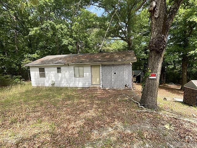 Opportunity awaits on approximately 1.25 wooded acres. This 2-bedroom, 1-bath home offers privacy, space, and potential at an affordable price point. Tucked among mature trees with room to spread out, this property is ideal for buyers looking for land, investment potential, or a project with usable outdoor space. This is a rare chance to own acreage and a shop in Little Rock at an accessible price. Just 15 minutes from the heart of town! No seller property disclosure. Buyers are encouraged to measure lot size and home square footage for themselves. Property is being sold as-is/where-is.