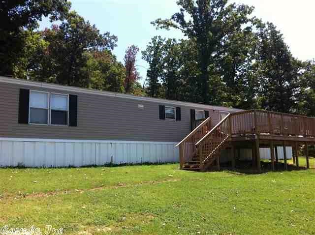 Peaceful serenity is what you will find tucked away on Crowley's Ridge with this 3 bedroom, 2 bath mobile home located between a hillside of woods and big boulders, with a gorgeous view all from your front deck. All electric home, carpet and vinyl, custom cabinets, built-in shelves and drawers in bedroom. Sits on paved road. The master bedroom has a walk-in closet, large tub. Split floor plan. Deck on back. 15x20 metal shop with roll top door on concrete.  Schedule your personal tour today!!