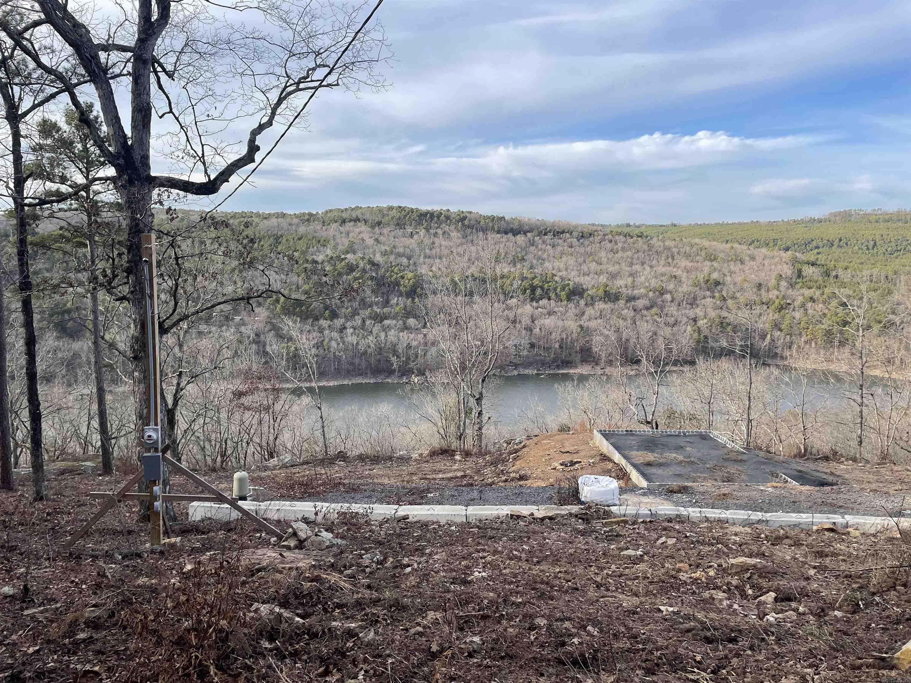Build your dream home on this beautiful 1.19-acre lake view lot offering stunning water views, peaceful surroundings, and the perfect blend of privacy and convenience. This property is already equipped with a well and power on site, providing an excellent foundation for your custom build, weekend retreat, or forever home. Enjoy breathtaking sunsets, year-round scenery, and the tranquility of lakeside living while remaining close to dining, schools, and recreation. Opportunities like this are becoming increasingly rare. Seller is willing to remove existing pad if desired.