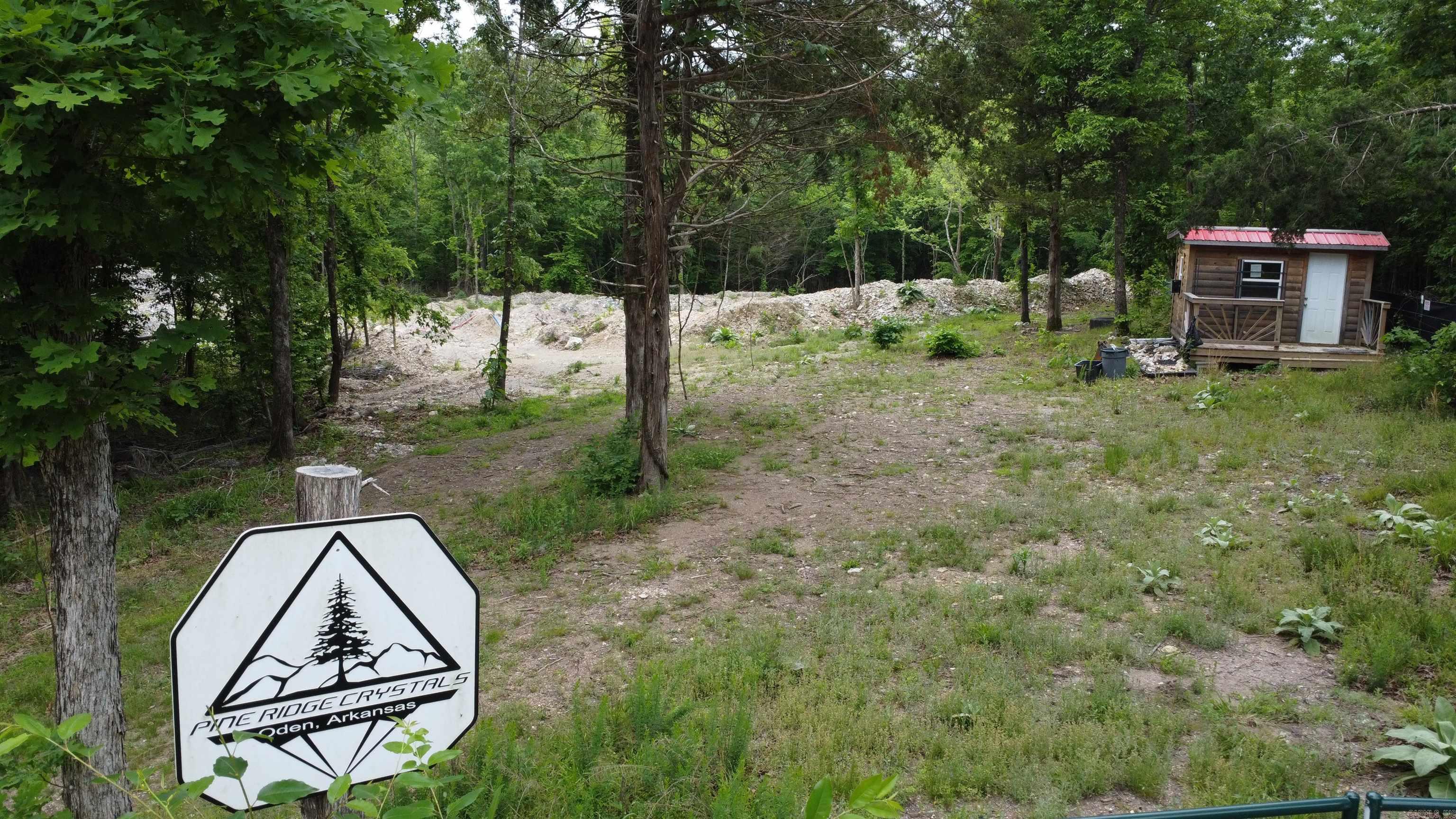 23.38 acres in Pine Ridge AR. Functioning/running quartz mine with 2 operating sites. Specimens of pyrite, smokey quartz, and clear water quartz. Joins Ouachita National Forest on the south side. There are 3 springs on the property as well. Gift shop. Pumps. 1991 excavator. MSHA inspected/approved. All mineral rights convey.  Running a quartz mine on private land has many advantages. The one advantages is not dealing with a Forest Service lease. Montgomery County is the quartz crystal capital of the world and offers a unique blend of rock hounds and tourists every year. But any specimens found, belong solely to the owner of the property.  Visits to the site are by appointment only. Give us a call for this exclusive opportunity.