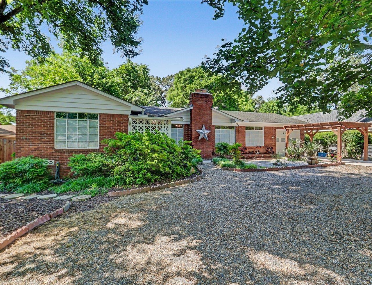 Located in a well-established Hot Springs neighborhood near Oaklawn Racing Casino Resort, this charming one-level home offers comfort, convenience, and family-friendly living. Featuring 3 bedrooms and 1.5 baths, the home includes beautiful hardwood floors, a cozy gas fireplace, and a spacious kitchen with abundant storage, gas cooking, and a Frigidaire Professional convection oven.  The large backyard is perfect for entertaining, pets, or play, with an updated patio, mature shade trees, and convenient alley access through an 8-foot rear gate.  Recent updates include HVAC (2021), water heater (2022), garage door (2022), pergola-style carport entry, and a whole-house surge protector.  Conveniently located near shopping, dining, parks, and schools in the Hot Springs School District, this home is also just minutes from Lake Hamilton and Oaklawn, offering easy access to some of Hot Springs’ most popular destinations.