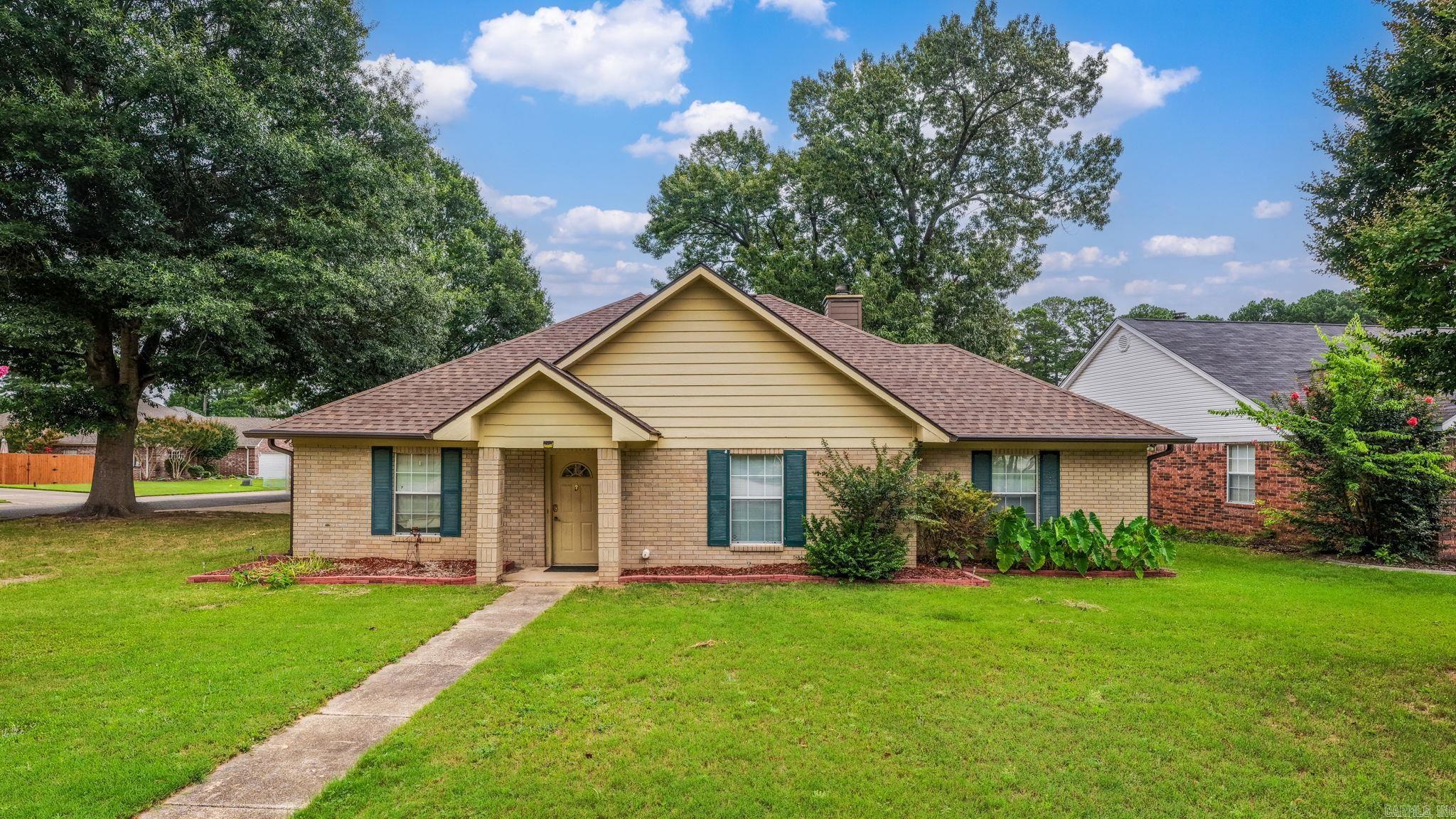 Tucked onto a corner lot on a a cul-de-sac, this Maumelle home is the rare opportunity to land in a sought-after neighborhood for well under the area's $350,000 average — and to make it entirely your own. Beneath a soaring vaulted great room, a fireplace anchors a space wrapped in built-in shelving and bathed in natural light. Original hardwood floors run through part of the home, rich and warm and impossible to replicate. The kitchen is built for gathering, with a center island, generous cabinetry, and an easy flow to both the formal dining room and the breakfast nook. Four bedrooms offer single-level ease, while fresh carpet, paint, countertops, and vanities await your personal touch — a blank canvas priced to let you build instant equity as you go. Outside, mature shade trees frame the corner lot, and a fully fenced backyard delivers room to roam plus a large detached storage building for tools, toys, or a workshop. No four-lane road here — just a peaceful cul-de-sac to call home. Bring your vision.