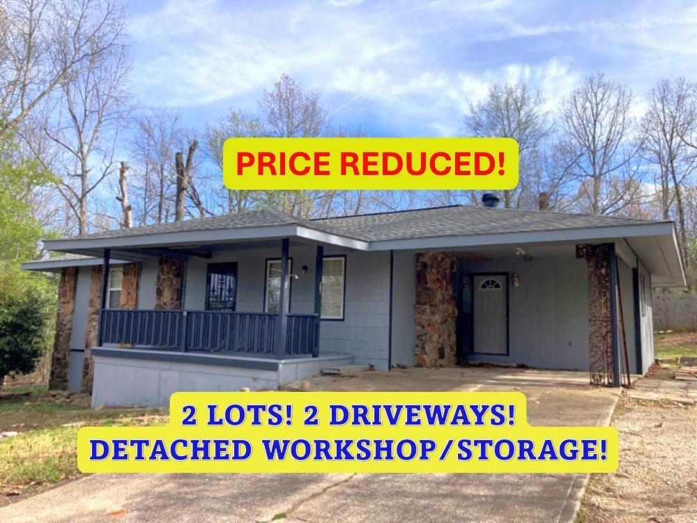 PRICED REDUCED!  HOME on 2 LOTS w/approx 18'x24' detached WORKSHOP/STORAGE and 2nd driveway! 2 Bedroom, 1.5 Bath home. This home has a big open floor plan with vaulted ceilings, new ceiling fan w/lights & native stone fireplace with gas hookup. Large Mudroom off the carport is perfect for extra space for a freezer and shelves for a pantry. Newer countertops and Gas Cookstove freshen up the kitchen. Nice large, tiled shower with seat in the hall bathroom and 2 good size bedrooms. All of the windows have been replaced with vinyl double pain windows. New 200-amp breaker box was installed 2 years ago to bring the electrical in the house up to today's needs. Approx 17'x8' Covered front porch and big back deck (approx. 15'3"x12'3") for family BBQs. The deck even has a propane hookup for your gas grill or you could use it for your patio heater! The second lot has had an additional driveway that goes to the side street for easy access to the detached shop/storage building and to better access the main road. Listing #2426.Measurements from ArCo Data