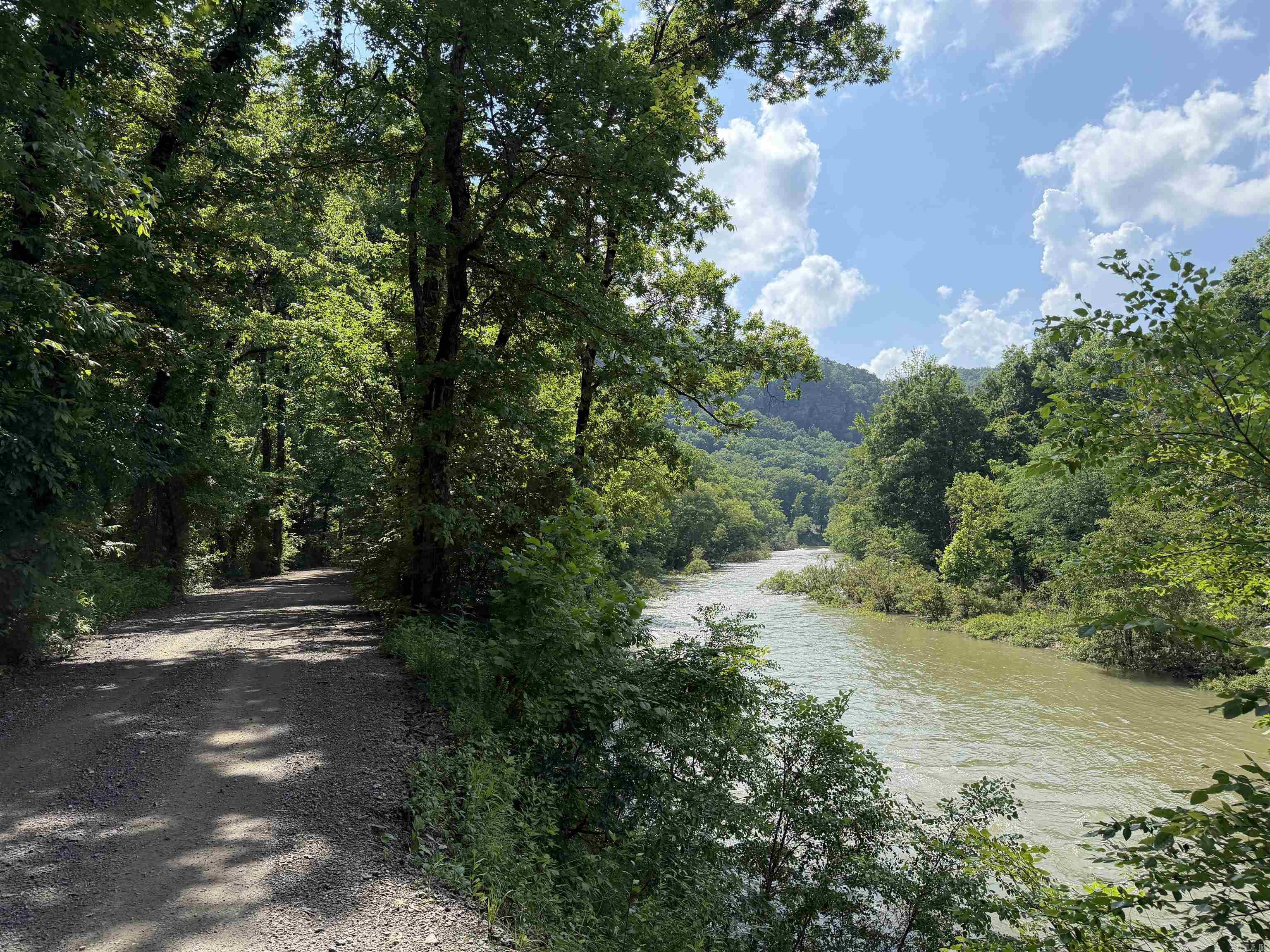Imagine a rural riverfront property where you can walk down to the water that makes a great kayak launching spot with a little sandy beach of your own on about two acres, just on the other side, or simply turn into your own gated driveway and drive up to the viewpoint where you will find a very, very secluded building pad waiting with a new septic system, well and storage building with a cleared out place in the middle of 40 acres surrounded by wildlife. The only thing you will need is solar panels or a quiet generator. You will be in the middle of nowhere, but  10 minutes from Shirley, Arkansas, aka small town America, and about 15 minutes from all the amenities of the resort retirement city of Fairfield Bay, Arkansas, and a 43,000-acre Greers Ferry Lake. This would be a great weekend home air b&b or a good place to retire. It's a must-see property with all kinds of potential because it provides you with fishing and hunting, kayaking, swimming, and nature watching