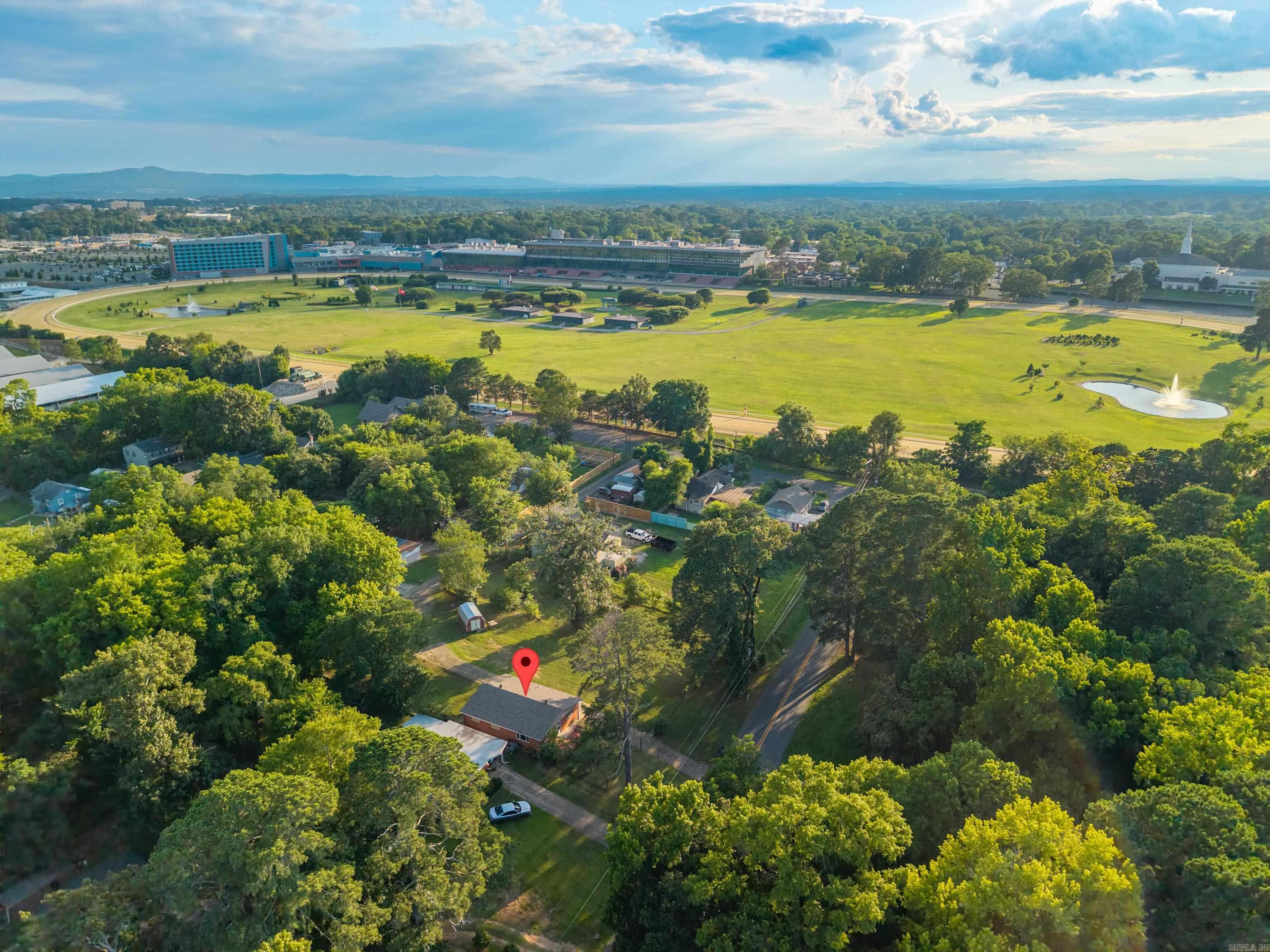Searching for a smart move in one of Hot Springs'most coveted pockets? This 3-bedroom, 1.5-bath home blends location, value, and serious upside into one tidy package. Set just around the corner from the famous Oaklawn racetrack, you'll be close to the thrill of the races and the steady stream of visitors that keeps this neighborhood buzzing year-round a savvy buyer's dream. Inside, 1,271 sq. ft. offers room to settle in and make it your own. A new roof and new windows mean fewer worries and lower bills. Three flexible bedrooms easily accommodate guests or a home office. The real kicker? Three lots, giving you space, privacy, and room to expand. Nearby, Hollywood Park delivers green space, while Walmart Neighborhood Market keeps errands simple. Properties combining this much location and potential rarely linger. Schedule your private showing today and stake your claim before someone else does!