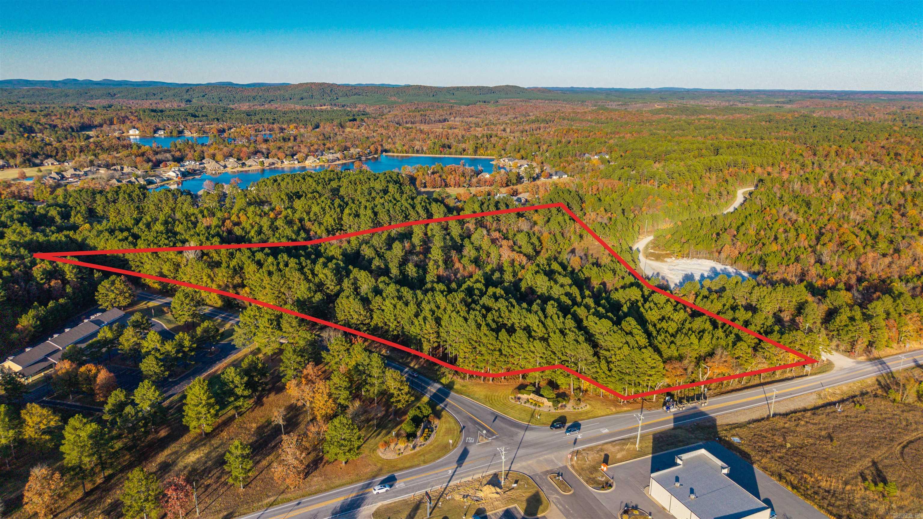 One-of-a-kind 15.35-acre commercial property positioned at the premier corner of Highway 5 and DeSoto Boulevard, anchoring the East Gate entrance of Hot Springs Village. This flagship tract commands exceptional frontage on both major corridors, ensuring maximum visibility, effortless access, and a constant flow of residents, guests, and contractors entering the nation’s largest gated community. With its scale, topography, and unmatched location, the site is ideal for high-impact development: commercial centers, medical or professional complexes, boutique retail, a car wash, bakery, restaurant, grocery, or multi-use investment projects. The east side of HSV is experiencing accelerating growth, increasing rooftops, and strong year-round demand. Investors will appreciate the powerful demographics, limited commercial competition, and long-term stability of this high-visibility corridor. A signature development site offering exceptional potential and lasting value.
