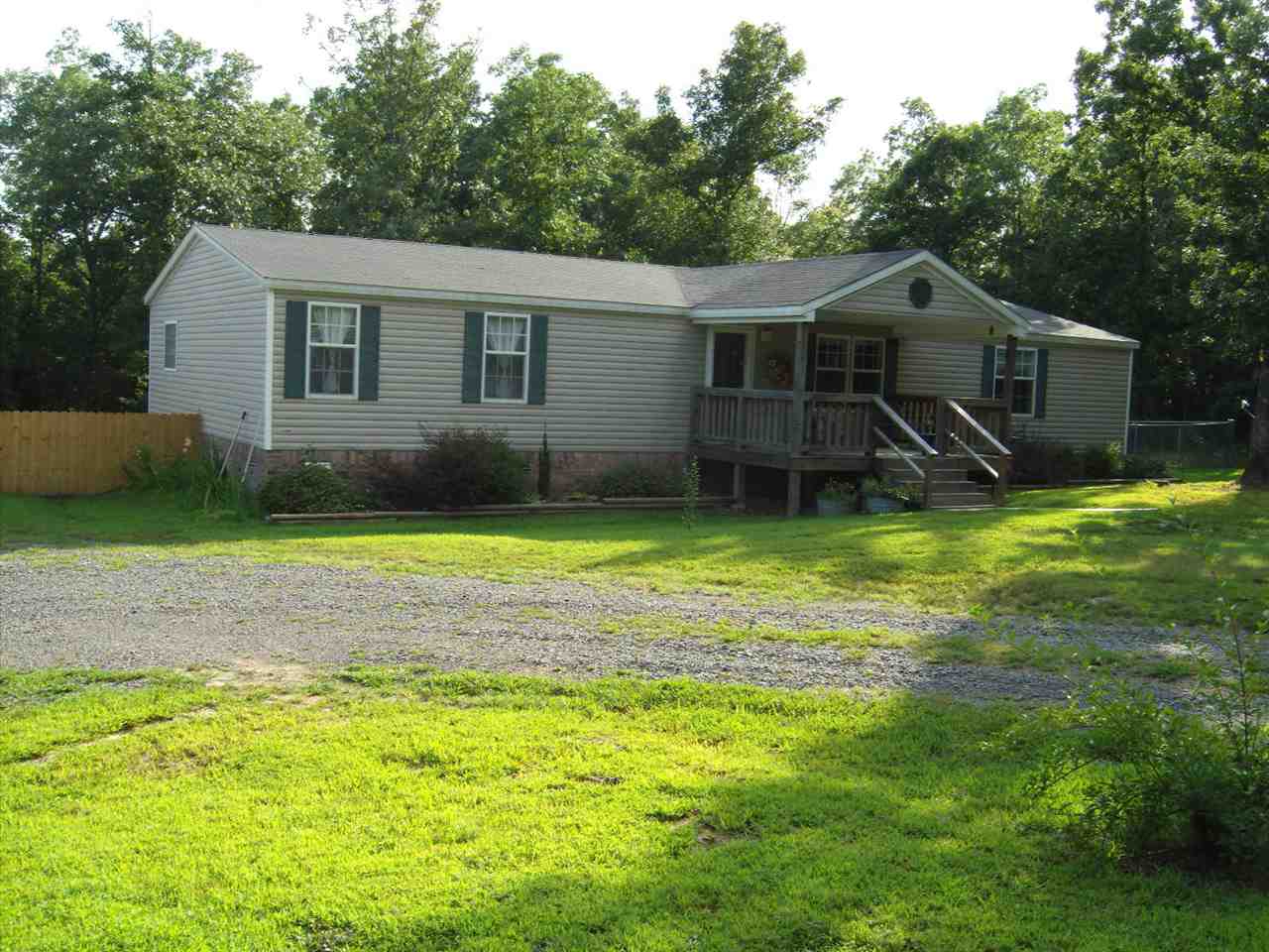 Beautiful double-wide home on permanent foundation, Open split floor plan, 3 or 4 bedroom or 3 and office, 2 full baths, walk in closet in 3 bedrooms, covered front porch, new large deck under construction, 30'x30' garage with two overhead doors, electricity and insulation, nice storm shelter,  fenced-in back yard, dog house, nice storage building, very nice private location, all sits on 10.63 acres, good hunting area.