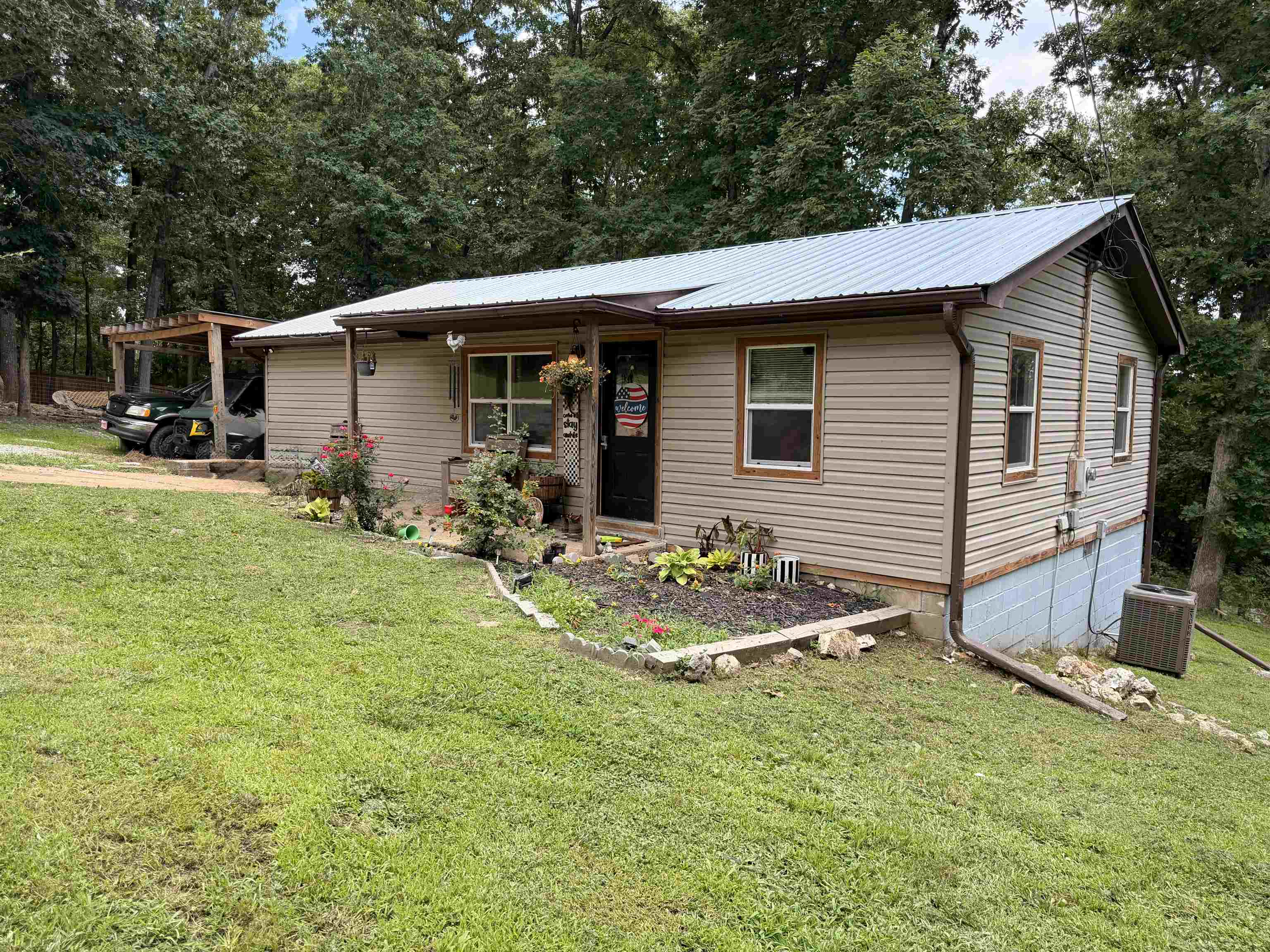Discover the perfect cozy retreat on three spacious lots in Ozark Acres! This charming home features newer roofing, flooring, HVAC, and a covered deck, providing comfort, style, and peace of mind. The expansive property offers plenty of space for gardens, recreational areas, hobby farming, or simply enjoying the outdoors. A 238 sq. ft. bonus room adds flexibility and is ideal for a home office, guest space, craft room, or additional living area. Conveniently located near local amenities and shopping, yet tucked away on a quiet street, this property offers the perfect balance of accessibility and tranquility.