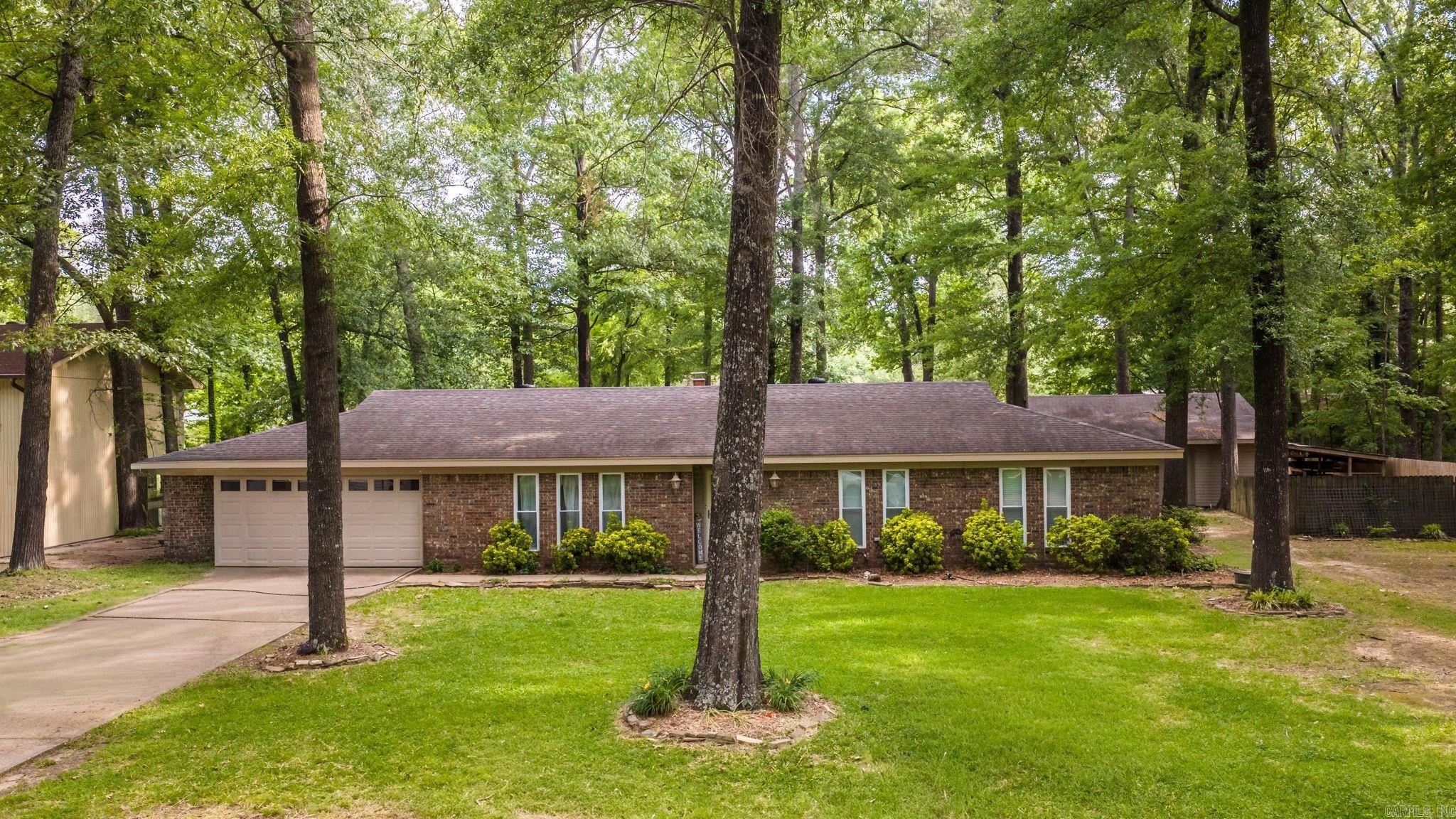 Hey, check out this rare gem in Conway! It’s a 3-bedroom, 2-bathroom 2,100-square-foot home sitting on a spacious 0.64-acre lot. The backyard is like a little park, with a playground, a fire pit, open areas, a zip line, a spot to hang a hammock, and a large 576-square-foot shop/pavilion with power. The shop is divided into two sections: one is 16 by 24 with dual garage doors so you can pull right through with your boat or trailer. The other side is 8 by 24 for tools and storage, with a pegboard on one side and built-in heavy-duty shelves on the other. Inside the home, you’ll find a large living room with a cozy wood-burning fireplace, a spacious formal dining room/office, and a separate den/playroom. All the bedrooms, including the primary suite, are spacious and peaceful. The main areas have tile flooring, updated lighting, and new flooring in one of the bedrooms. Both bathrooms have been updated with granite countertops, cabinets, shower tile, lighting, fixtures, and paint. This home has a lot to offer for the price. $3500 flooring allowance for Replacement of the carpet in 2 of the bedroom.