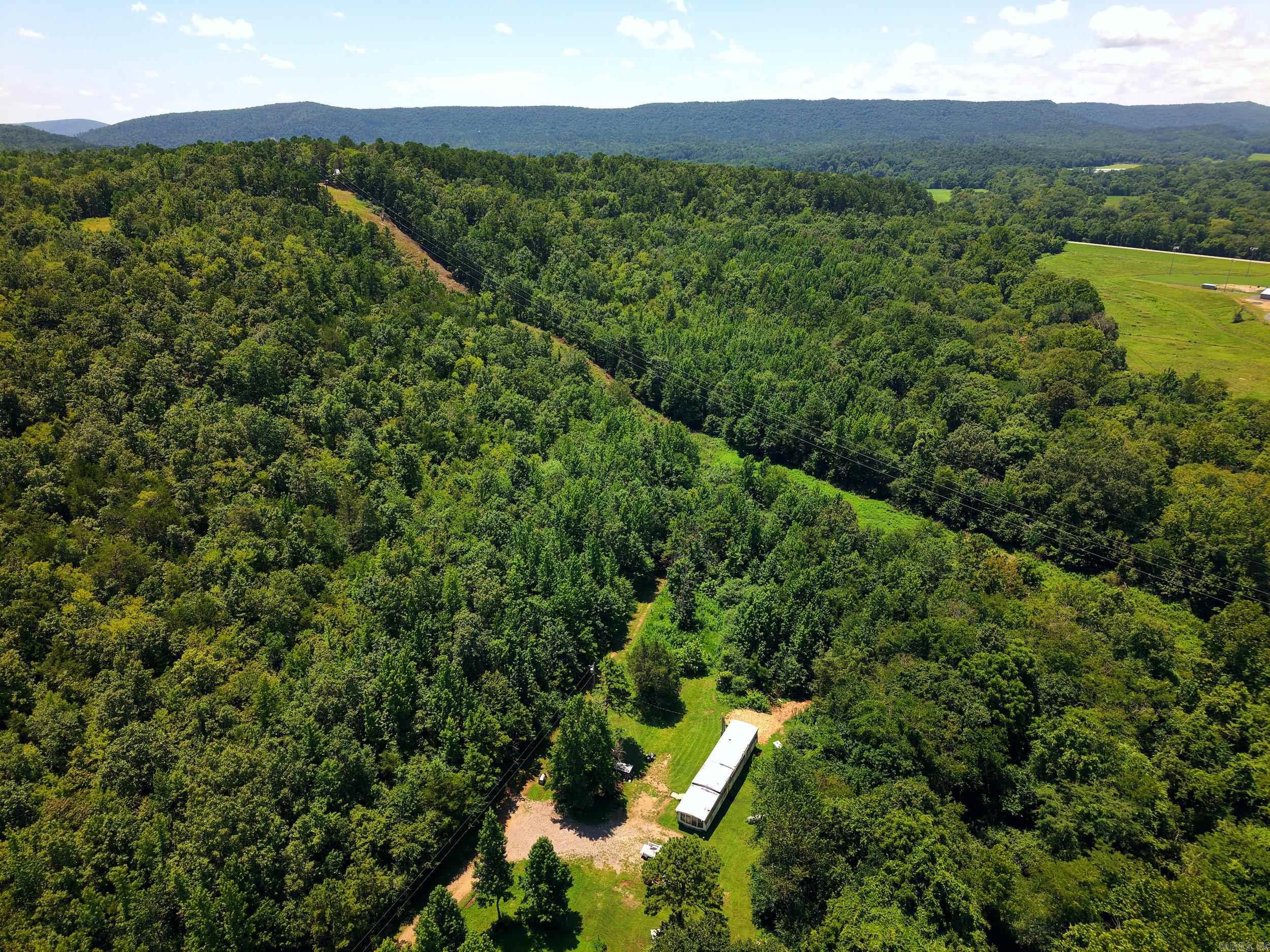Approximately 20± acres offering a versatile mix of mature timber and open pasture, located on a dead-end road. This property provides a great opportunity for hunting, recreational use, agricultural purposes, or building a custom home. Improvements include two wells, two septic systems, and a small pond just a short distance from Colliers Creek. With a blend of wooded and open areas, the property is well-suited for a hobby farm, weekend getaway, or a property with space for multiple homes. Agents see remarks.