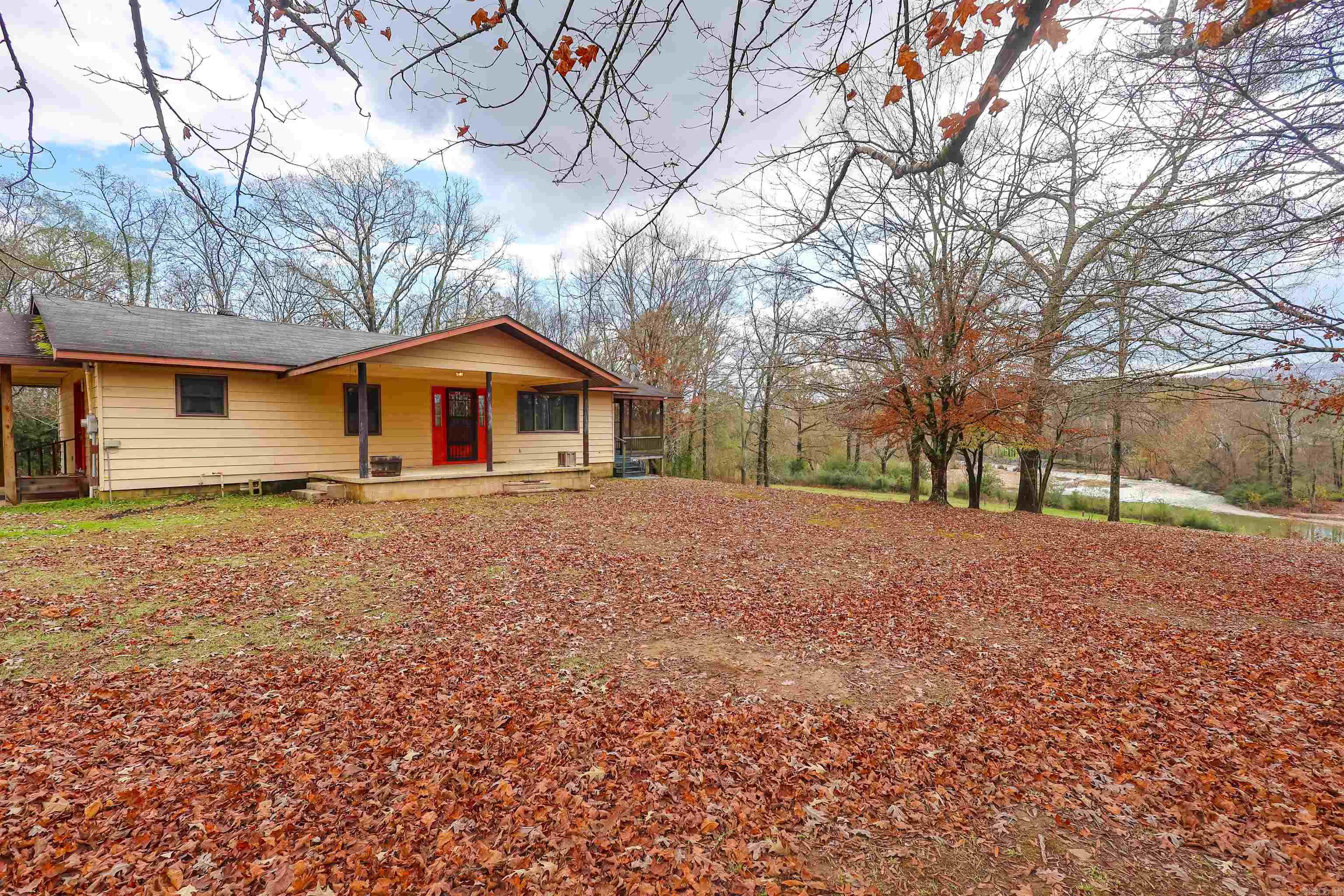Situated along the beautiful Caddo River, this approximately 7.5-acre property offers direct water access and a scenic natural setting that’s increasingly hard to find. With a blend of open and wooded acreage, the land provides a versatile canvas for recreation, relaxation, or future development. Enjoy fishing, kayaking, and taking in spectacular river views right from your own property.  The existing home offers a functional starting point for those looking to update, renovate, or build over time. Whether you're searching for a weekend retreat, investment opportunity, or a place to create your own riverfront escape, this property presents exceptional potential with its acreage, river frontage, and flexible use.