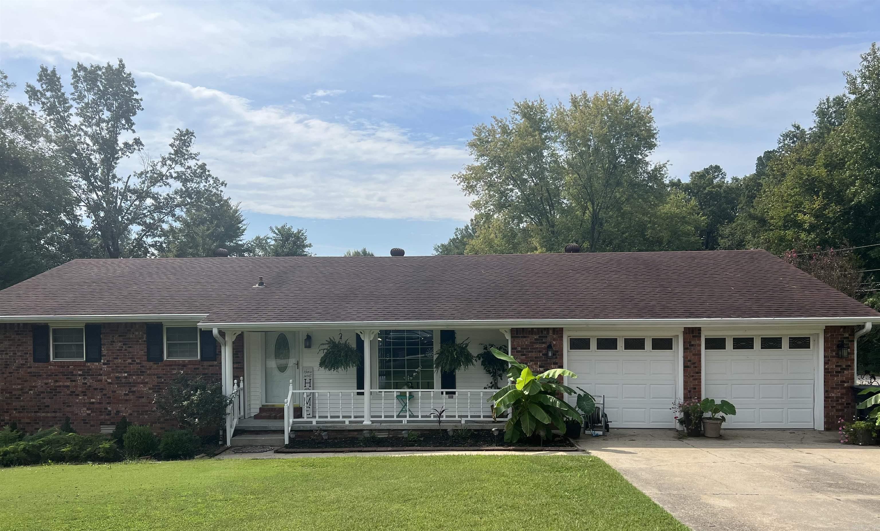 Beautiful brick ranch home on large corner lot! MOVE IN READY!11 1126 Pleasant View Ln is located in Piggott AR and it has a lot to offer its new owners! This beautiful brick ranch home has 1528 sq ft. It sits on a large beautiful corner lot with beautiful landscaping, in a highly sought after area of town. It has two bedrooms and two baths. Primary bedroom has an ensuite and walk in closet. This home has an open concept floor plan joining the living, dining areas and kitchen. The kitchen is very spacious with tiled counter tops and flooring. There is an abundance of cabinet and counter space. The kitchen peninsula is large and is a great space for family meals. The Stainless Steele refrigerator, dishwasher, and stove convey with the home. Appliances are about a year old. Just off the dining and kitchen area is the back deck overlooking the backyard. There is an outside storage building (12 x 16) with electricity. The laundry room is oversized with two storage closets and built in cabinets providing lots of storage options. There's an entryway from the two car garage into the laundry room just off the kitchen. Updates include flooring, lighting, toilets, and paint. Must see!