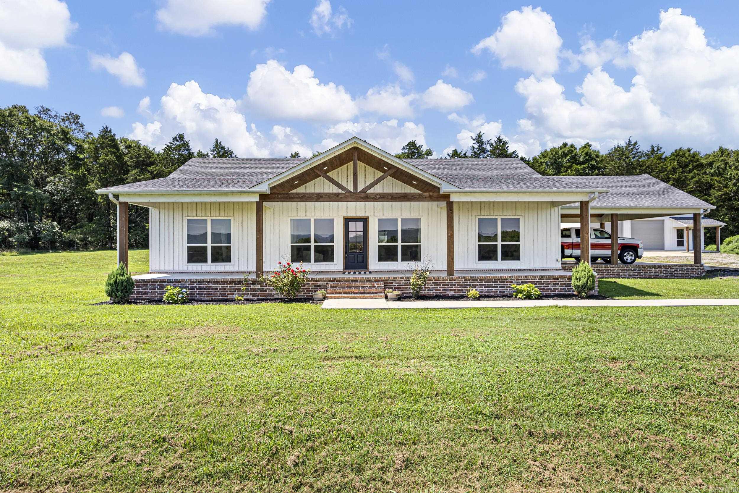 If you've been dreaming of peaceful country living with room to breathe, this is the one.  Nestled on 10 pristine acres with breathtaking Ozark Mountain views, this beautiful home is less than 5 years old and offers the perfect blend of modern comfort and rural charm. Featuring 3 bedrooms, 2 full baths, and a thoughtfully designed layout, you'll love starting your mornings on the front porch with a cup of coffee while taking in the rolling mountain scenery. A 40x40 shop provides ample space for equipment, hobbies, a workshop, or storing all your toys.  Whether you're looking for a quiet place to call home, a hobby farm, or your own slice of Arkansas paradise, this property delivers the lifestyle you've been searching for.