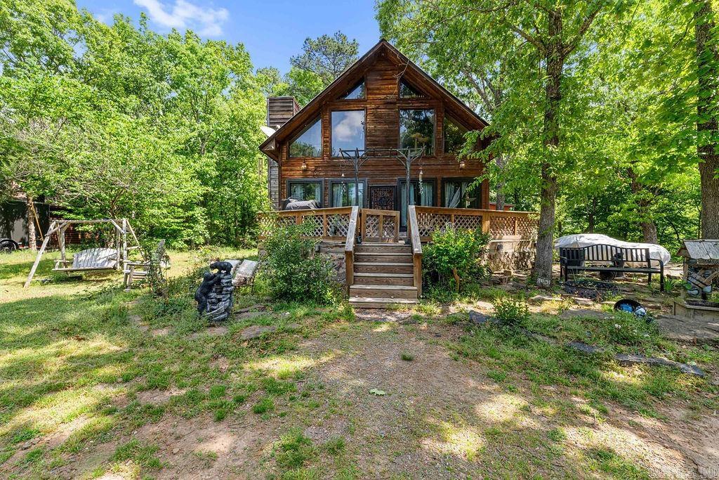 Tucked away near Greers Ferry Lake, this 3-bedroom, 2-bath home offers the perfect blend of cozy cabin style and modern comfort. Step inside to a warm, inviting living space featuring a beautiful fireplace and rustic finishes that give it that sought-after cabin feel. The updated kitchen boasts brand-new appliances, making it as functional as it is stylish. The unique loft-style third bedroom adds character and flexibility, perfect for guests or a private retreat. Outside, enjoy two spacious decks overlooking peaceful wooded surroundings—ideal for relaxing mornings or entertaining in the evenings. With a handy storage building for all your lake toys and outdoor gear, this property is the perfect escape for full-time living or a weekend getaway.