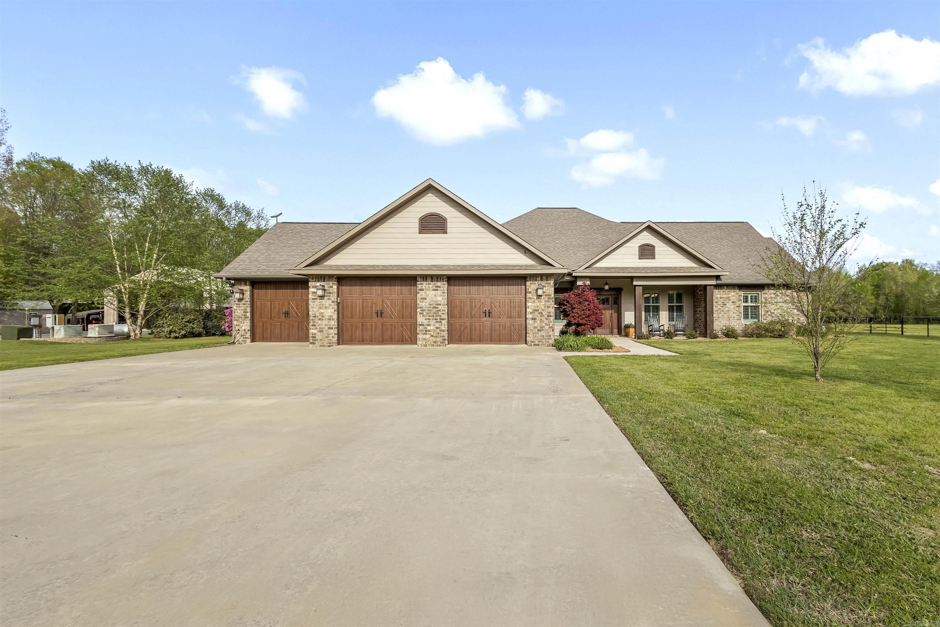 This 34.77-acre country estate combines luxury living with exceptional functionality. The 3,344 sq ft home features 3 bedrooms, 2.5 baths, and an office that can serve as a 4th bedroom. Interior highlights include hickory floors, custom cabinetry, crown molding, and an open layout ideal for entertaining. The kitchen is fully equipped with a commercial-grade gas range, double ovens, built-in fridge/freezer, nugget ice maker, quartz countertops, and a large island.  The primary suite offers a spa-like retreat with a clawfoot tub, walk-in shower, and custom closet. Outdoor living shines with a screened porch, pellet stove, flagstone patio, pergola, and multiple entertaining areas. A resort-style backyard includes an inground pool, cabana with bath and outdoor shower, and hot tub.  Additional amenities include a pickleball court/RV space, workshop, barns, dog kennel, 3-car garage, whole-home generator, and more. With wooded and open land, it offers privacy, recreation, and versatility.