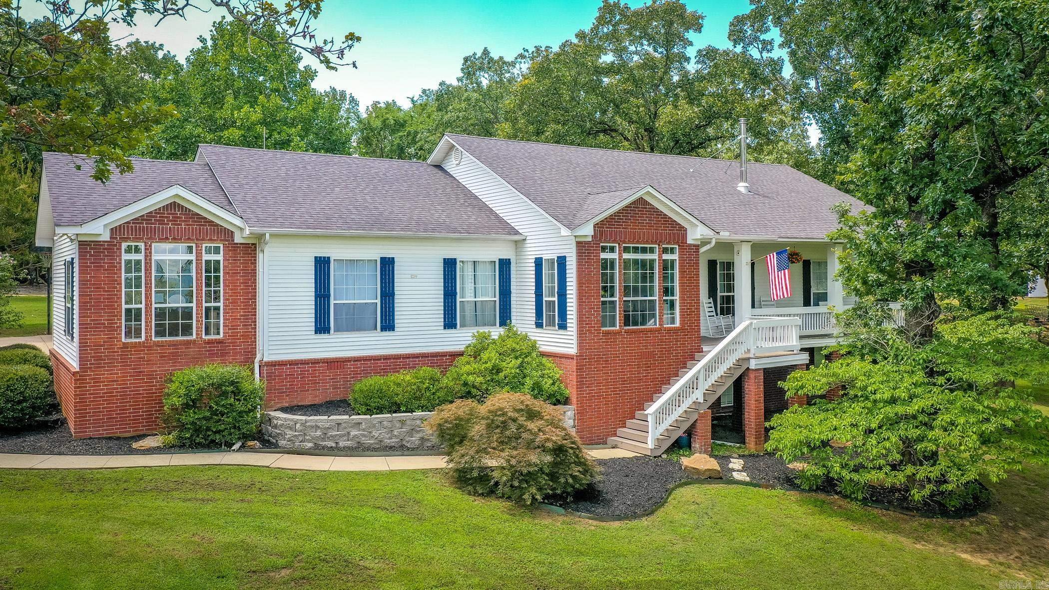 Elevated atop 7.2 acres of rolling countryside, this meticulously maintained two-owner home offers sweeping views, front porch charm & timeless character. Sunlight fills the expansive windows, bringing the beauty of the surrounding acreage into everyday living. Beyond the traditional 3-bedroom, 2-bath layout, you'll find oversized bedrooms & common spaces, a finished basement that could serve as a 4th bedroom, a dedicated office, and versatile flex space off the primary suite—ideal for a library, sitting room, nursery, or private office for focus & calm. The spacious primary suite also features a large walk-in closet, jetted tub, separate shower & dual vanities. The kitchen presents abundant cabinetry, generous quartz counter space & updated appliances. Outside a 24x24 shop is perfect for hobbies or projects, while a pond, pasture, hay barn, loafing shed, raised beds & chicken coop all provide endless opportunity for hobby farming, livestock & gardening. A rare combination of quiet privacy, dynamic versatility & breathtaking views—schedule your showing today & experience the commanding landscape, the possibilities, and lifestyle that make this extraordinary property unforgettable.