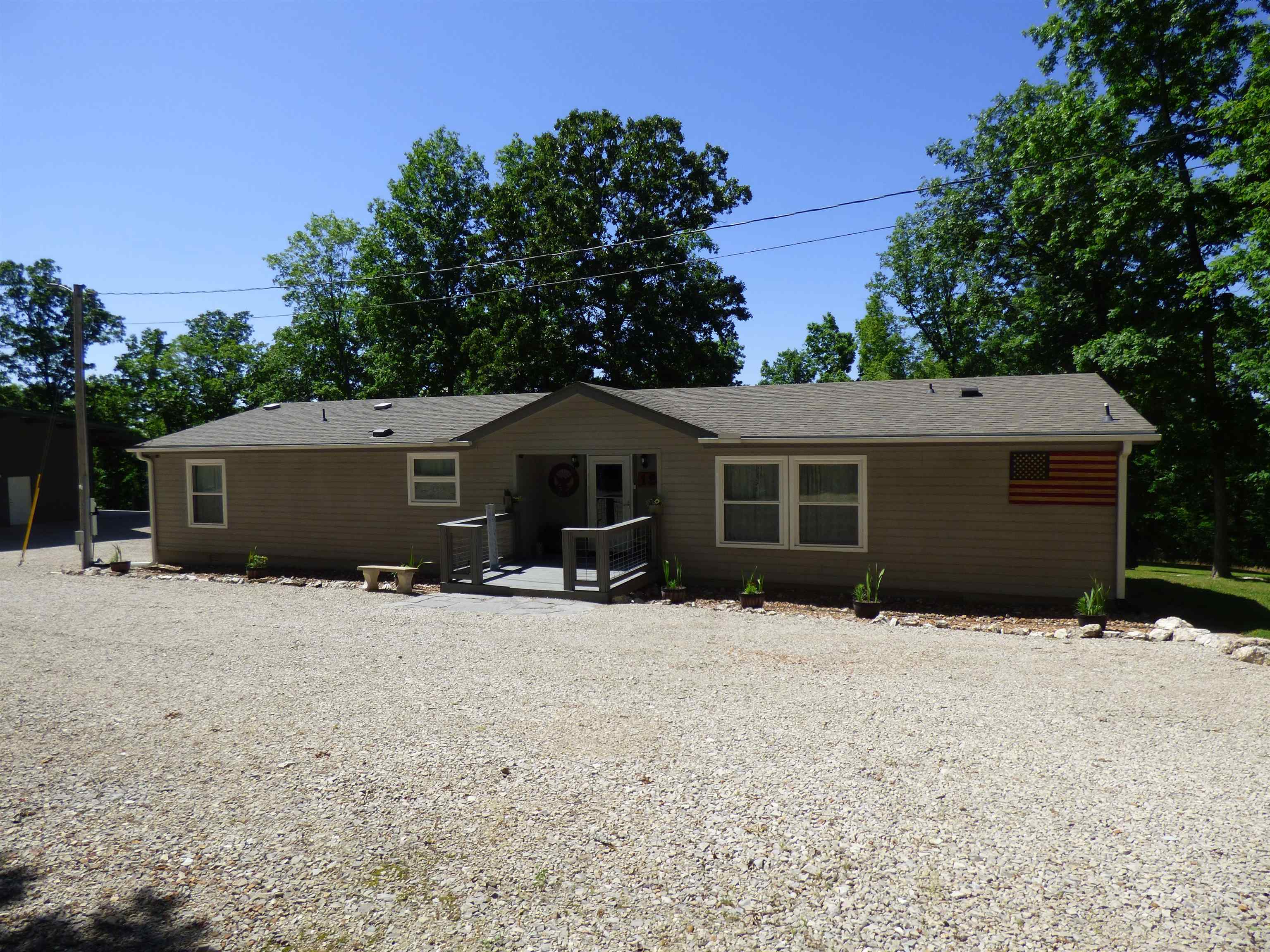 Where nature and convenience come together.  This beautiful 1900sq foot home & 40X50 shop sits on one cleared acre and is surrounded by 9 wooded acres, giving you a total of 10 acres of scenic landscape and a chance to experience the  wildlife that make this area so special. Deer roaming and birds singing make this home feel like a true escape.  Updated practical features - Newer roof, gutters, downspouts, windows, doors, decks and HVAC system.  Then step inside to enjoy the light and airy open concept kitchen, dining and living space, with thoughtfully chosen updates throughout. From beautifully updated flooring, large kitchen and newer appliances, gorgeous bathrooms and spacious bedrooms for family or guests.  The storm shelter lends peace of mind and is easily accessed and the propane system offers heat in the shop and back up heat in the house. The huge 2000 sq foot shop makes it the perfect place for work or play.  Located minutes from Historic Down Town Hardy and the Spring River this home is a must see!