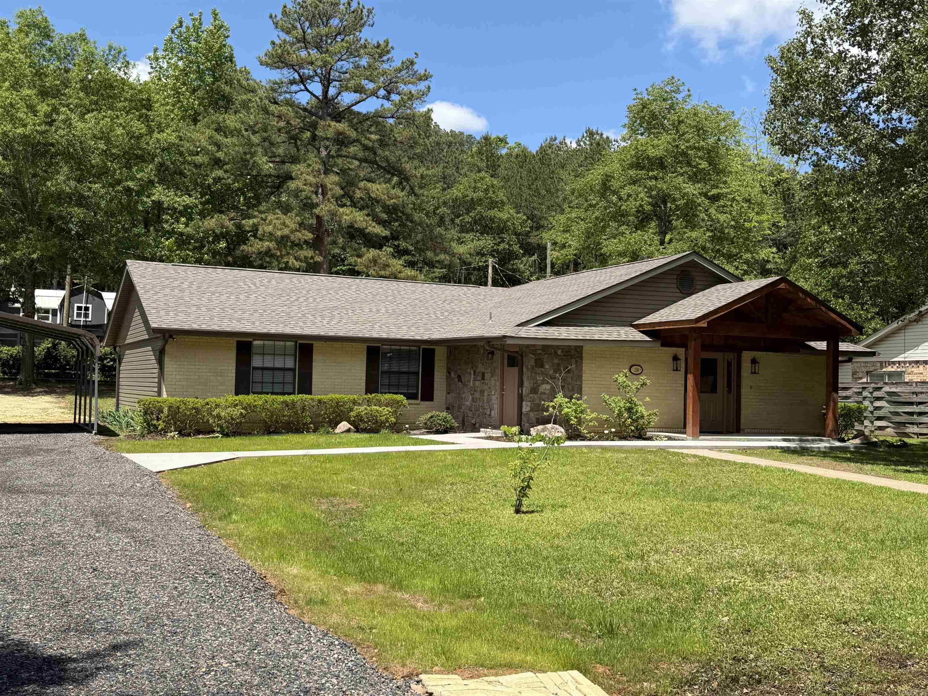 Completely remodeled, top to bottom, just like a brand new home! Enjoy the luxury of premium workmanship in this home that features a new roof, new HVAC, new plumbing, new light fixtures, new electrical panel, new plugs and switches, new entrance, new water heater, hard wired smoke detectors - even a brand new entrance, sidewalks and a new porch! One foot of cellulose insulation has also been added - there's not much that isn't brand new in this home! New sheetrock, doors, trim, flooring - the house has been gutted and remodeled to feature wide open living/kitchen/dining, all with engineered hardwood flooring. The kitchen also has a large pantry, quartz countertops, stainless appliances and lots of cabinets! The dining room features a wood tray ceiling and doors that open to the back of the property. Additionally, there is a coffee bar and a large laundry/mud room. The bathrooms have tiled showers and more quartz countertops. Large walk-in closet in the primary bedroom. Also has a two-car carport, a nice shop, and an additional outbuilding, plus another entrance off Simpson Street - so much to offer! Beautiful color scheme throughout. Also has a new driveway and great landscaping!