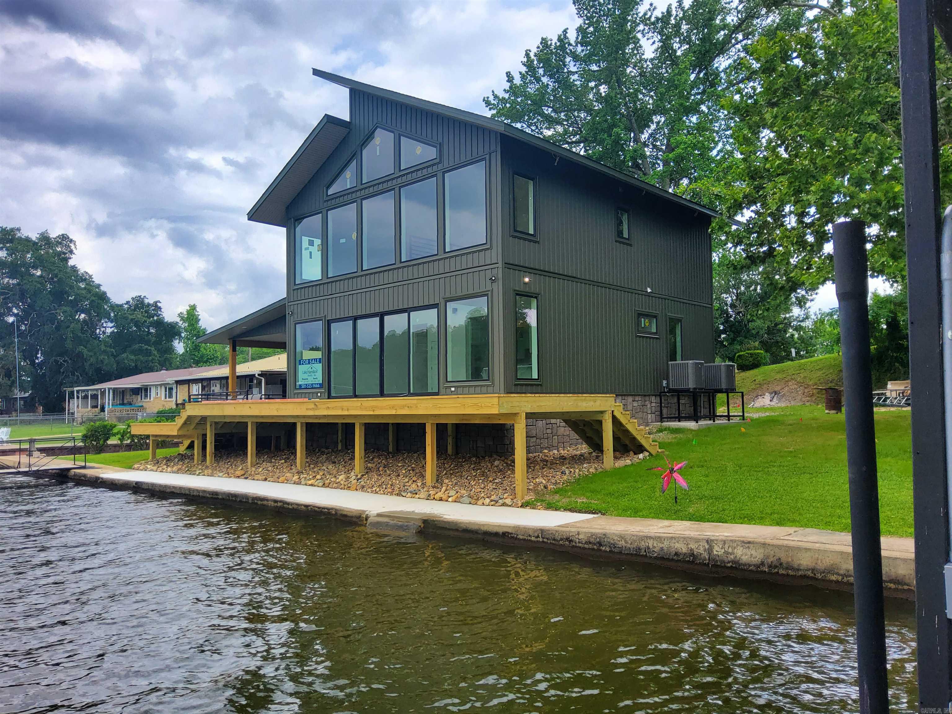 Lakefront living at its best is now complete in this beautifully crafted home featuring  upscale finishes and spacious designs.  The LAUNCHING ramp is rare but this home also has oversized swim dock and two boat docks.  The HUGE covered patio and deck sare perfect for entertaining or relaxing.  The upper loft area has many options.  Professional photos will be taken as soon as possible.
