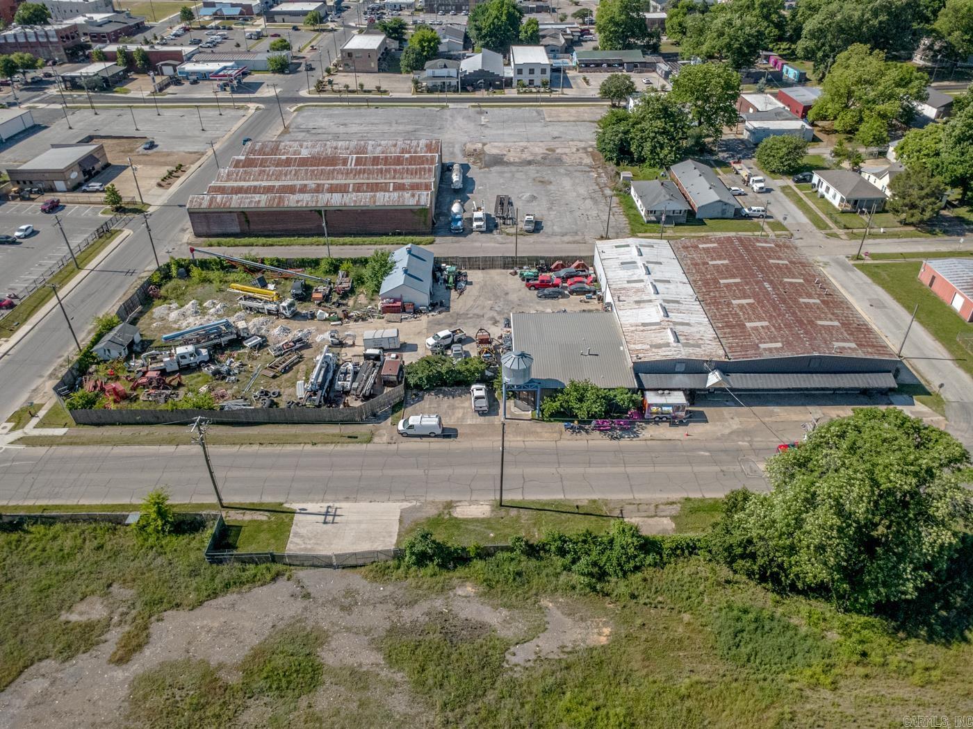 Welcome to Market 301 Burke Ave in Jonesboro, AR within an established industrial/commercial corridor near downtown. Situated on 1.18 +/- acres spanning 9 city lots, this property holds 16,664 sf of office/warehouse space offering flexibility for contractor, fabrication, distribution, storage, service, and business operations. The metal building is accented by multiple office spaces, conference/work areas, mezzanine storage, warehouse sections, roll-up/loading access, fenced outdoor storage areas, and paved parking/work space. The property is serviced by city water, sewer, electricity, and natural gas and is zoned C-1. The combination of office space, warehouse functionality, outdoor work/storage areas, and central location creates opportunity for owner-users, expanding businesses, investors, or operational headquarters. Surrounded by established commercial, rail corridor, service, warehouse, and downtown business activity, the property offers strong accessibility within the Jonesboro market. Rare opportunity to acquire a property w/ scale, infrastructure, flexibility, and operational potential. Call today to make an investment in tomorrow.