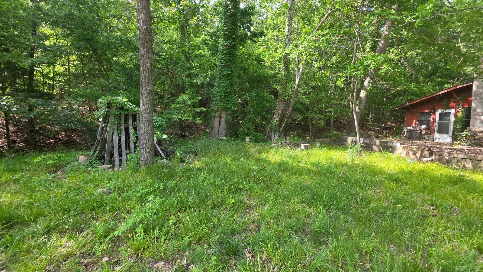Older home sits on 20 ac M/L Bull Shoals Lake access less than 10 miles away. Pond and outbuilding. Homes is 4239 SQ ft built in 1985 was originally known for canning tomatoes. Needs work has been vacant and exposed to moisture. $299,000