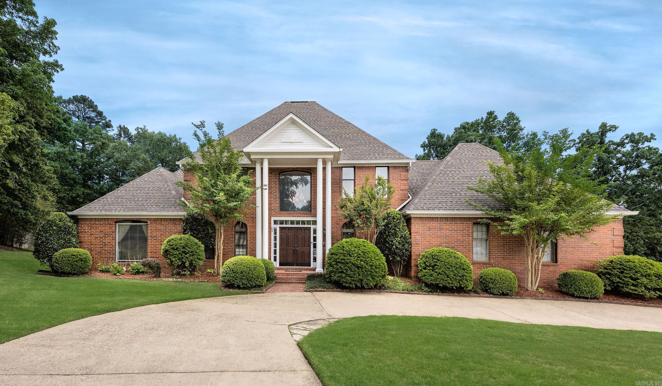 Luxury living meets timeless elegance in this exceptional Pleasant Valley Estates home located in one of West Little Rock’s premier gated communities. Situated on a beautifully landscaped 0.74-acre lot, this expansive 5-bedroom, 4.5-bath residence offers approximately 5,900 square feet designed for both entertaining and everyday comfort. The spacious floor plan features soaring ceilings, abundant natural light, a grand entry, formal dining room, office/study, game room, bonus room, and a dedicated media/theater room. The main-level primary suite provides a private retreat with a sitting area and spa-like bath. The gourmet kitchen is equipped with double ovens, gas range, large island, breakfast bar, pantry, and generous cabinetry, opening seamlessly to inviting living spaces with fireplaces and custom details throughout. Additional highlights include hardwood and tile flooring, wet bar, central vacuum, safe room, walk-in closets, and extensive storage. Enjoy the covered patio and private backyard setting perfect for relaxing or entertaining guests. Experience luxury, space, and privacy in an unbeatable location—schedule your private showing today!