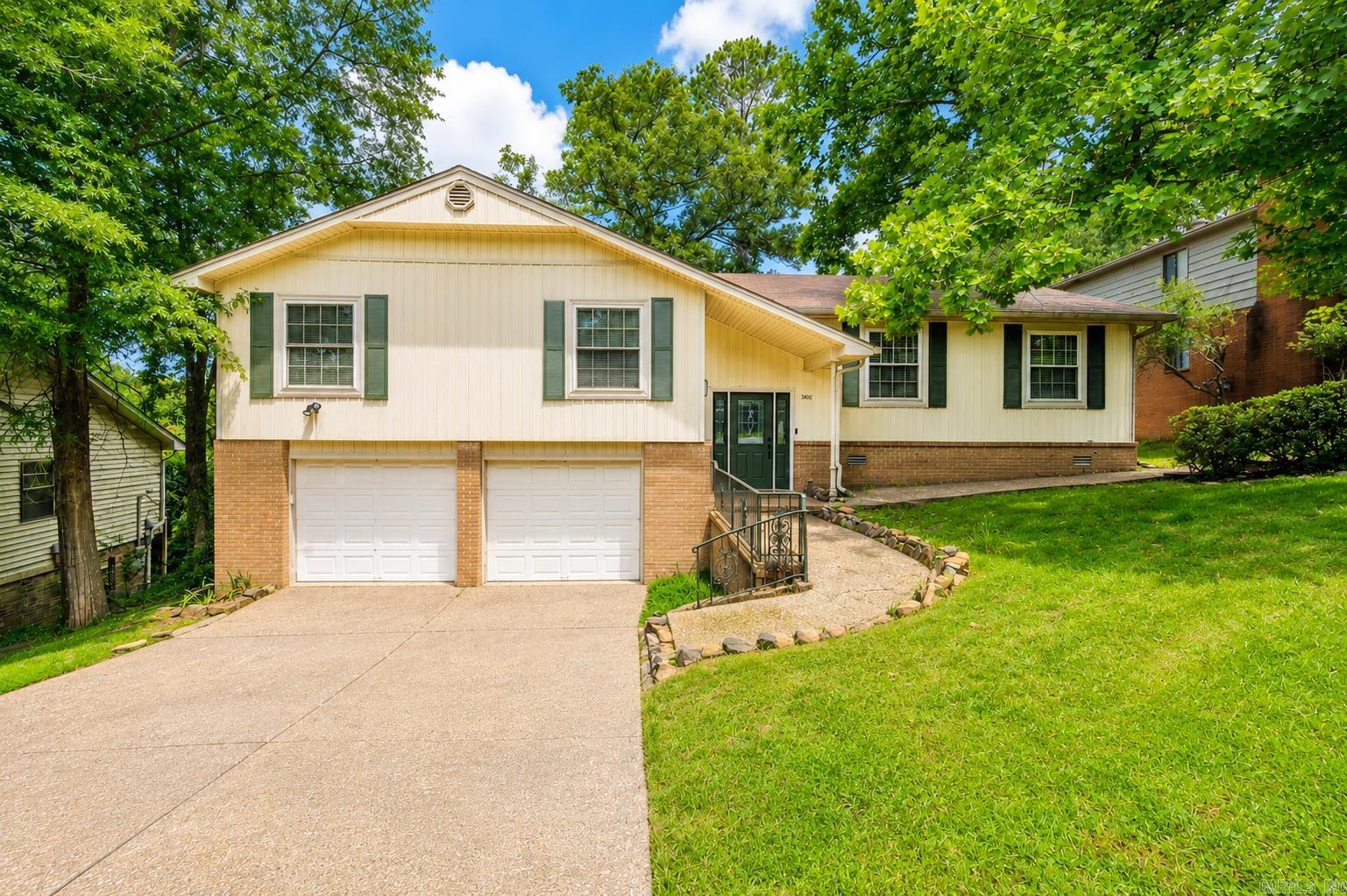 Check out this beautifully updated home in the heart of Little Rock, conveniently located near shopping, dining, medical facilities, and easy freeway access! This spacious 4-bedroom, 2.5-bath home offers three separate living areas and has been refreshed with new flooring, fresh paint, recessed lighting, window blinds, and updated fixtures throughout. Newer windows provide abundant natural light and improved energy efficiency.  The main level features an open living and dining area that flows seamlessly into the updated eat-in kitchen, complete with freshly painted cabinetry, double ovens, an electric cooktop, dishwasher, pantry, and refrigerator that conveys. Just off the kitchen, the cozy hearth room with a brick fireplace creates the perfect space for relaxing or entertaining.  The primary suite offers double closets and an updated bath with a tiled walk-in shower. Downstairs, you'll find a spacious bonus room with a half bath, ideal as a game room, media room, home office, or playroom. An oversized laundry room provides additional storage and functionality.  Step outside to a peaceful, tree-shaded backyard featuring a two-level deck designed for entertaining family and friends.