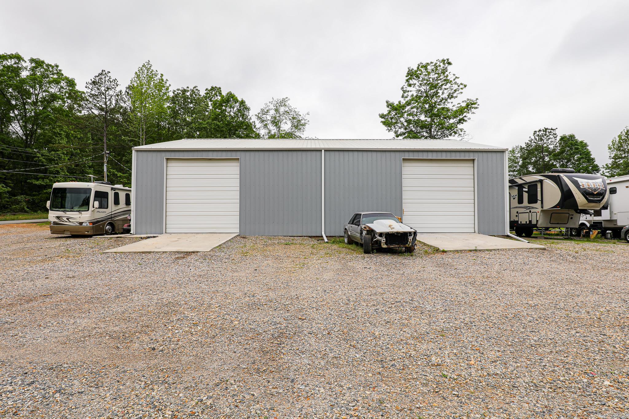 NICE TRACT WITH A 2 BAY SHOP BEING USED RIGHT NOW AS A FIBERGLASS BUSINESS. SEVERAL OFFICES HAVE BEEN WALLED UP BUT NOT FINISHED. SEPTIC IS IN AND BEING USED ON A COUPLE OF RV'S. THIS WOULD MAKE A GREAT AREA FOR STORAGE BUILDINGS OR FOR AUTOMOBILE USE OF ANY KIND. WITH AN ACCEPTABLE OFFER SELLER WOULD BE WILLING TO GET THE BACK PART OF THE PROPERTY FILLED IN WITH DIRT.