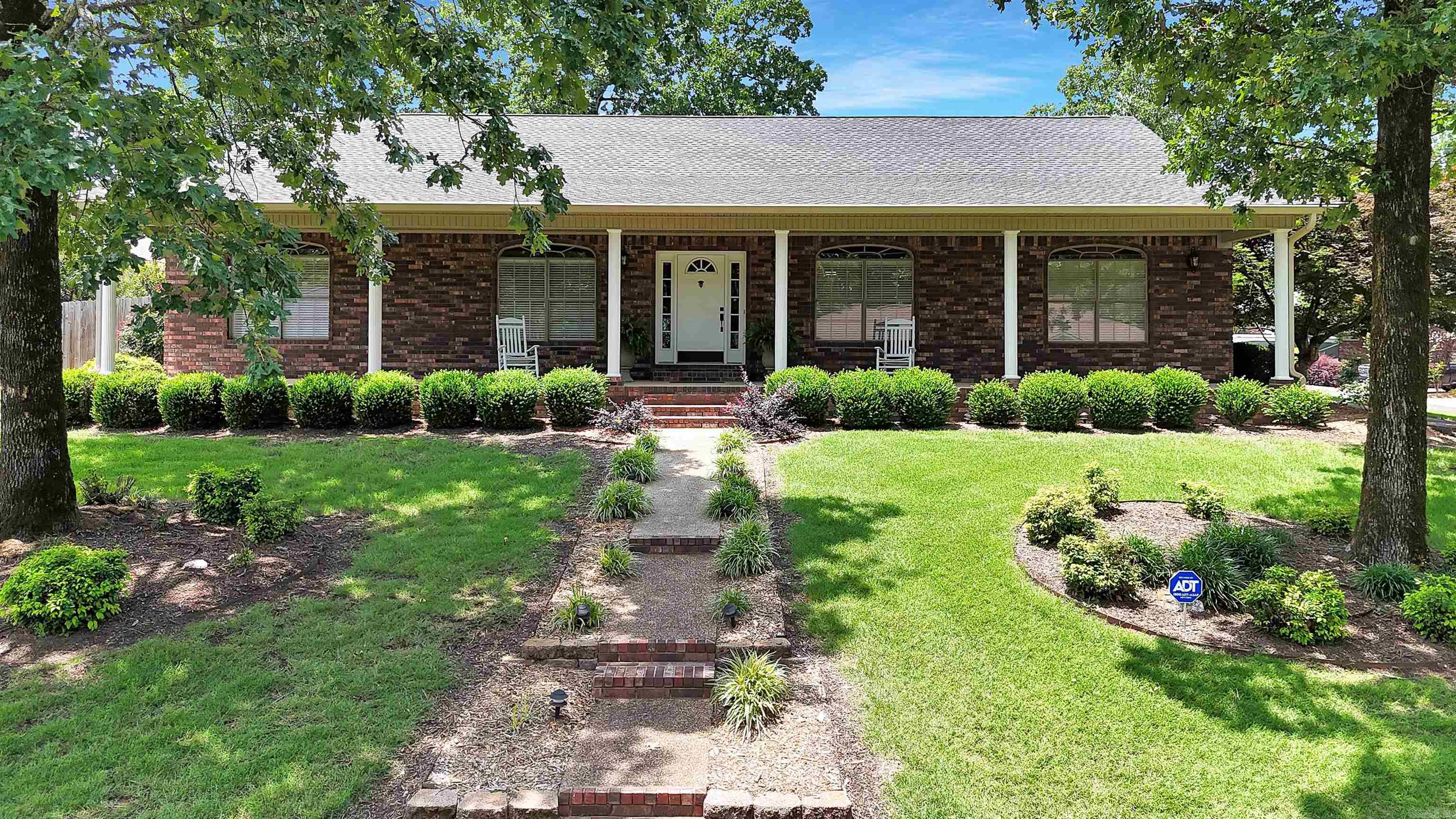 Welcome to this lovely home located in a highly sought-after neighborhood in LHSD. As you approach the home, you’re welcomed by an inviting exterior with a full length covered porch and mature lush landscaping creating a picturesque view that complements the home perfectly. As you step inside the sprawling one-level home you’re greeted with beautiful wood floors, vaulted & tray ceilings, an inviting wood-burning fireplace with gas logs in the living room, and a split bedroom layout that includes 4 bedrooms and 4 full bathrooms—yes, everyone gets their own! The kitchen and living areas are thoughtfully designed with ample space for gatherings or simply spreading out in comfort. The large primary suite features his & hers vanities, a large walk-in closet, a walk-in shower, and jetted tub perfect for soaking away the day. Separate laundry room has a utility sink, ample cabinetry, and a handy bar for hanging clothes. The oversized garage has a dedicated mechanical room and a workshop in the back. Outside, your private oasis awaits you with a wood privacy fence, covered patio, a 10x16 storage building, and a separate water meter helps keep your yard watered without draining the wallet.