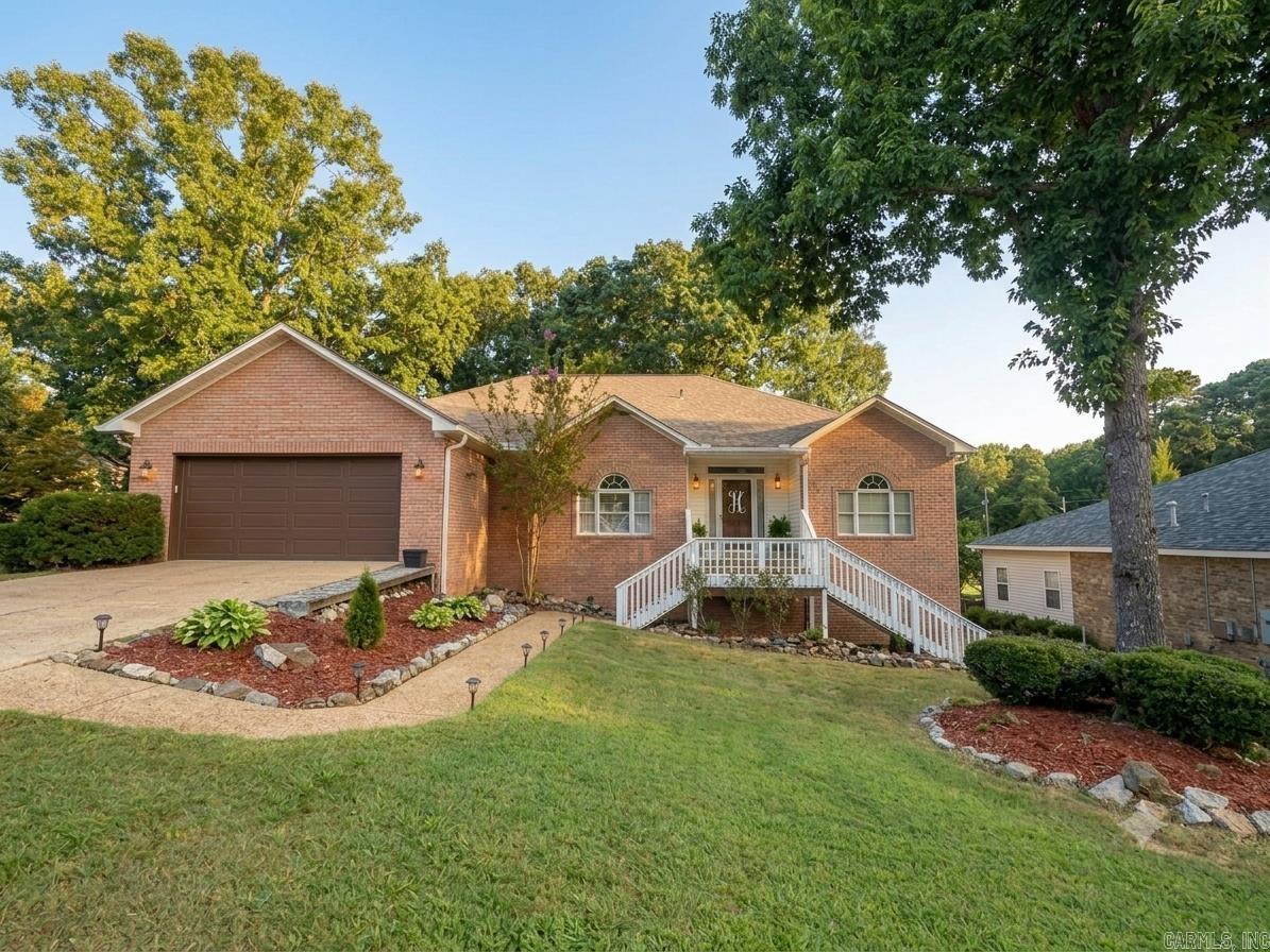 This well-maintained brick home offers a spacious and great floor plan perfect for comfortable living and entertaining. Featuring 4 bedrooms, 2 bathrooms, 4th bedroom is upstairs loft measuring 14' x 35'. The home includes granite countertops in the kitchen, a convenient 2-car garage, a dedicated laundry room, and peaceful sun porch to relax and watch the sunset on Lake Hamilton.  Below the main level, a LARGE workshop offers excellent space for hobbies, projects, or additional storage, along with adjoining unfinished multi-purpose areas ready to be customized to fit your needs whether for a home gym, studio, or extra living space.  Located in the desirable Lake Hamilton School District, this property combines space, flexibility, and potential all in a great location. HOA includes private Boat slip access on Anderson St.