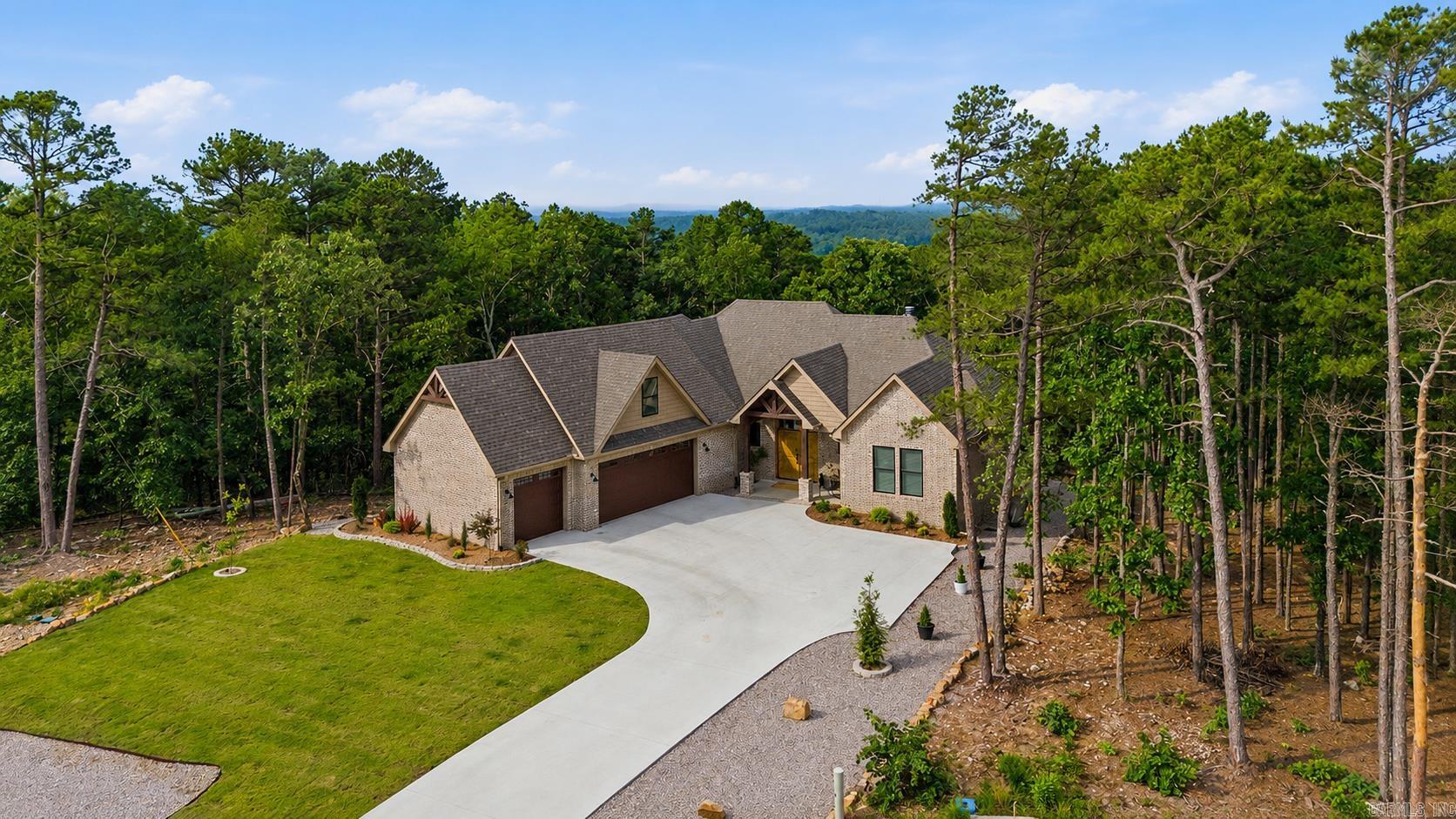 Tucked away among the pines in a quiet, peaceful neighborhood, this beautifully crafted home offers the perfect blend of comfort, privacy, and convenience. Vaulted ceilings and large windows fill the open living area with natural light while showcasing beautiful views of the surrounding woods.  The kitchen is designed for both everyday living and entertaining, featuring a gas range, natural quartzite countertops, and a walk-in pantry with butcher block countertops. A dedicated office, spacious bonus room, mudroom with custom cubbies, and golf cart garage provide the flexibility and functionality today's buyers are looking for.  The primary suite offers a spa-like retreat with a curbless walk-in shower, while nearly every window captures peaceful views of nature. During the winter months, seasonal vista views stretch across the surrounding landscape.  Step outside onto the back deck and into the trees, where you can enjoy the tranquility of the natural setting. Conveniently located near the Balboa Gate, Danville Gate, and Lake Balboa Beach.  Hot Springs Village has a one-time new member buy-in fee of $2,000. Agent owned.