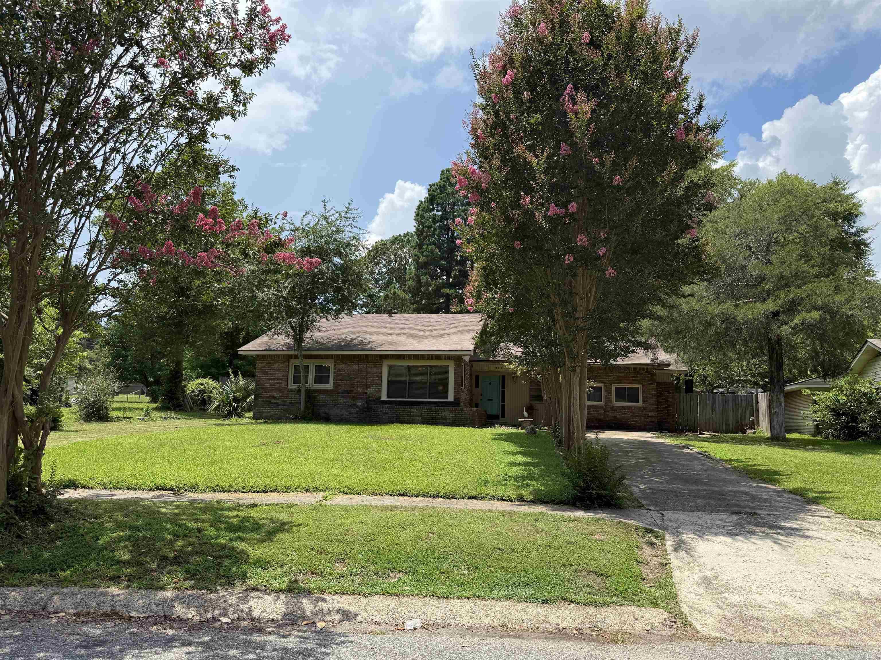 Affordable opportunity in the heart of Arkadelphia! Located at 1563 Center Street, this 3 bedroom, 1 bath home with a bonus room offers flexible space for a home office, playroom, hobby room, guest area, or additional living space. Full of character, the home features painted paneling, warm ceiling details, updated-style flooring in several areas, and a layout ready for the next owner’s personal touch. The spacious kitchen and dining area provide everyday function, while the covered back patio is perfect for morning coffee, relaxing evenings, or family gatherings. One of the standout features is the massive backyard backing up to S 16th Street, offering room for pets, play, gardening, outdoor entertaining, or future possibilities. The owner is especially proud of the locally gathered Caddo River rock used throughout the walkway, fire pit area, and backyard features. Great option for an owner-occupant, rental property, value-add investment, or flip opportunity. Marketing video/photos may include AI-assisted virtual staging to help buyers visualize the home’s potential with furniture; actual property is shown in its current condition.
