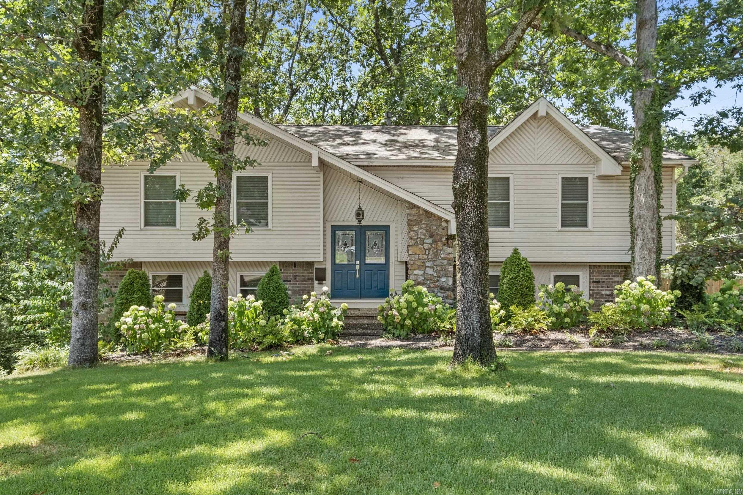 Move-in ready and beautifully updated, this Indian Hills home sits on a quiet cul-de-sac on a spacious 0.60-acre lot just minutes from shopping, dining, and schools. Offering 3 bedrooms, 2.5 baths, two living areas, a bonus room, and an inground pool, there's room for everyone! The main level features an open living area with abundant natural light, new flooring and paint, flowing into the dining area and fully remodeled kitchen with new cabinetry, countertops, stainless steel appliances, subway tile backsplash, updated fixtures, and refrigerator that conveys. The main-level primary suite includes a beautifully remodeled bath with a new walk-in tiled shower. Two additional bedrooms and a full bath complete the main level. Downstairs offers a second living area with a brick fireplace, half bath, spacious laundry room with storage, and a flexible bonus room for office, gym or storage. Enjoy the park-like backyard featuring a pool with a new liner, covered cabana with electricity, deck, fire pit, storage sheds, and mature trees for privacy. Roof approximately 4 yrs. Newer windows. Two-car garage with extra parking. Schedule your showing today!