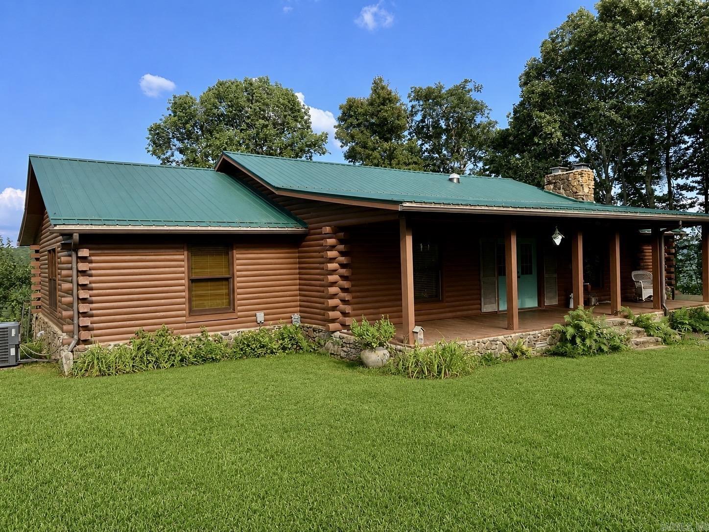 Imagine sitting on your back porch as you watch the sunrise across an absolutely stunning Ozark Mountain valley with the Middle Fork of the Little Red anchoring it all. That is only one of the amazing features of this property. The 2520 sq ft home has 2 bedrooms and 2 custom bathrooms. There is also a very large bonus room that could be converted into another bedroom or two if desired. Other features include: hardwood and tiled flooring, a wood burning stove in the living room, a gas log fireplace in the master, and custom showers. This home offers an abundance of comfort and class. Many updates have been done within the past 6 years including: a new HVAC, new plumbing, a new roof, and new energy efficient doors and windows. Outside features include: a 30x30 shop, a fully fenced in and established organic garden spot, a spacious greenhouse, a whole house Kohler generator, a 2200 water catchment system for the garden, and even a chicken coop. Boasting 85 acres of beautiful land with lots of mature trees, rock formations, and even a cave...this is an outdoor paradise. The gated entrance ensures plenty of privacy. Your dream home, corporate getaway, or luxury rental awaits.