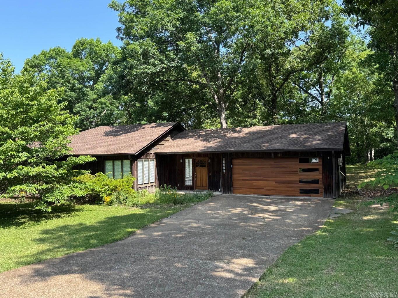 This well maintained home features bamboo flooring in most of the home, updated windows and updated baths. The living area is a great size and has large windows. The kitchen features stainless appliances accented with a beautiful walnut countertop! The renovated bathrooms are fabulously unique from the cypress walls to the Batesville limestone counter tops and custom tiled showers. The backyard has a fenced area, wonderful deck and a great pergola for entertaining, many trees, and storage closet.