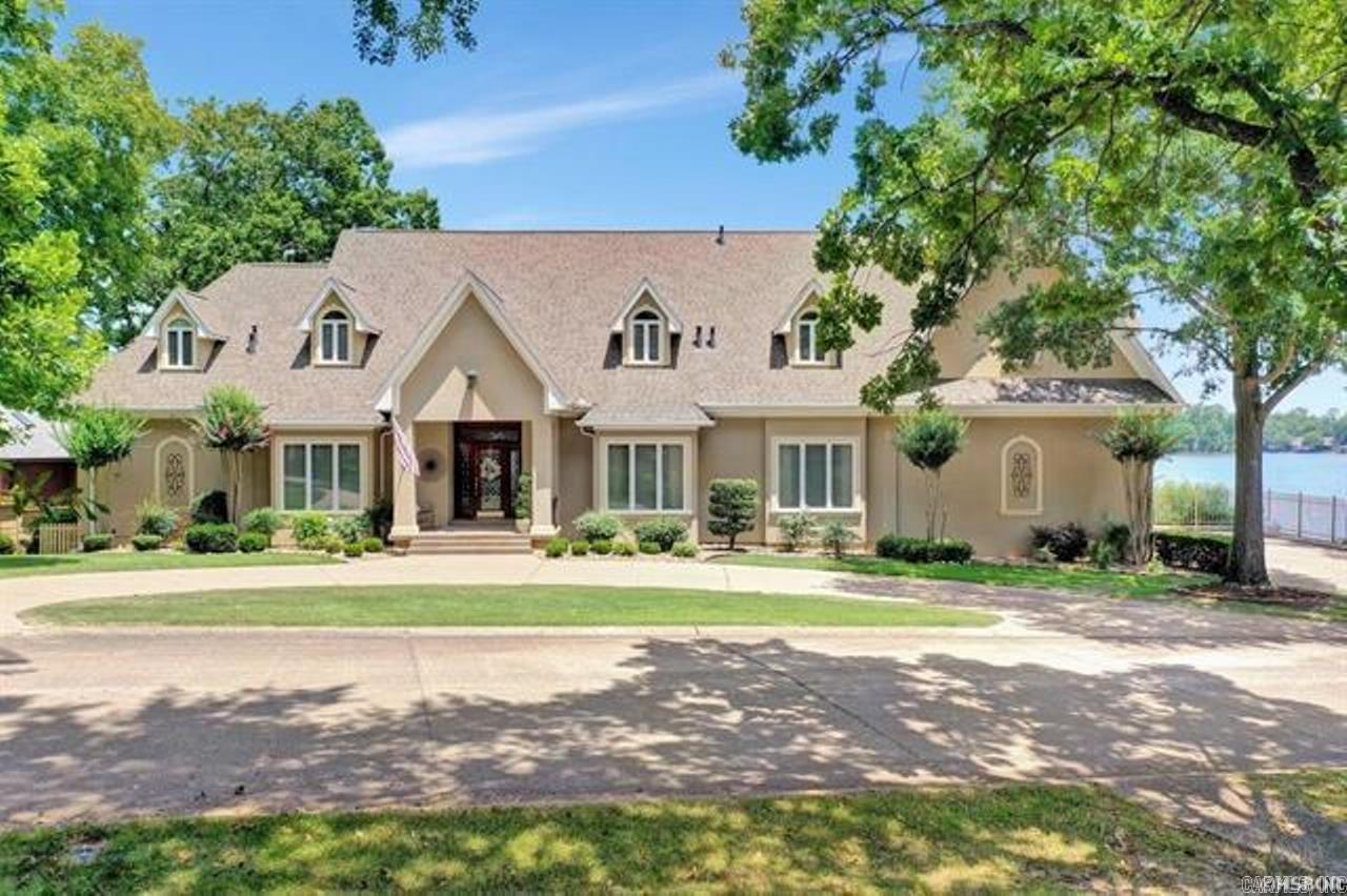 This Lake Hamilton beauty is what dreams are made of. From the moment you walk thru the door graceful elegance and a view straight out to the water will take your breath away.  Hardwood floors, a master chef kitchen, large open floor plan perfect for entertaining and floor to ceiling lake views.  5 bedrooms, 3 and a 1/2 baths, 2 informal living areas, 2 kitchen areas, a master suite to die for, office, exercise and bonus space to boot! Outside features 3 patios, a lakeside hot tub and 2 stall covered dock!  You deserve the very best life has to offer so check Find My Dream Home off your list - 'cause you found it!  Come see for yourself why you can't wait to get packin'.