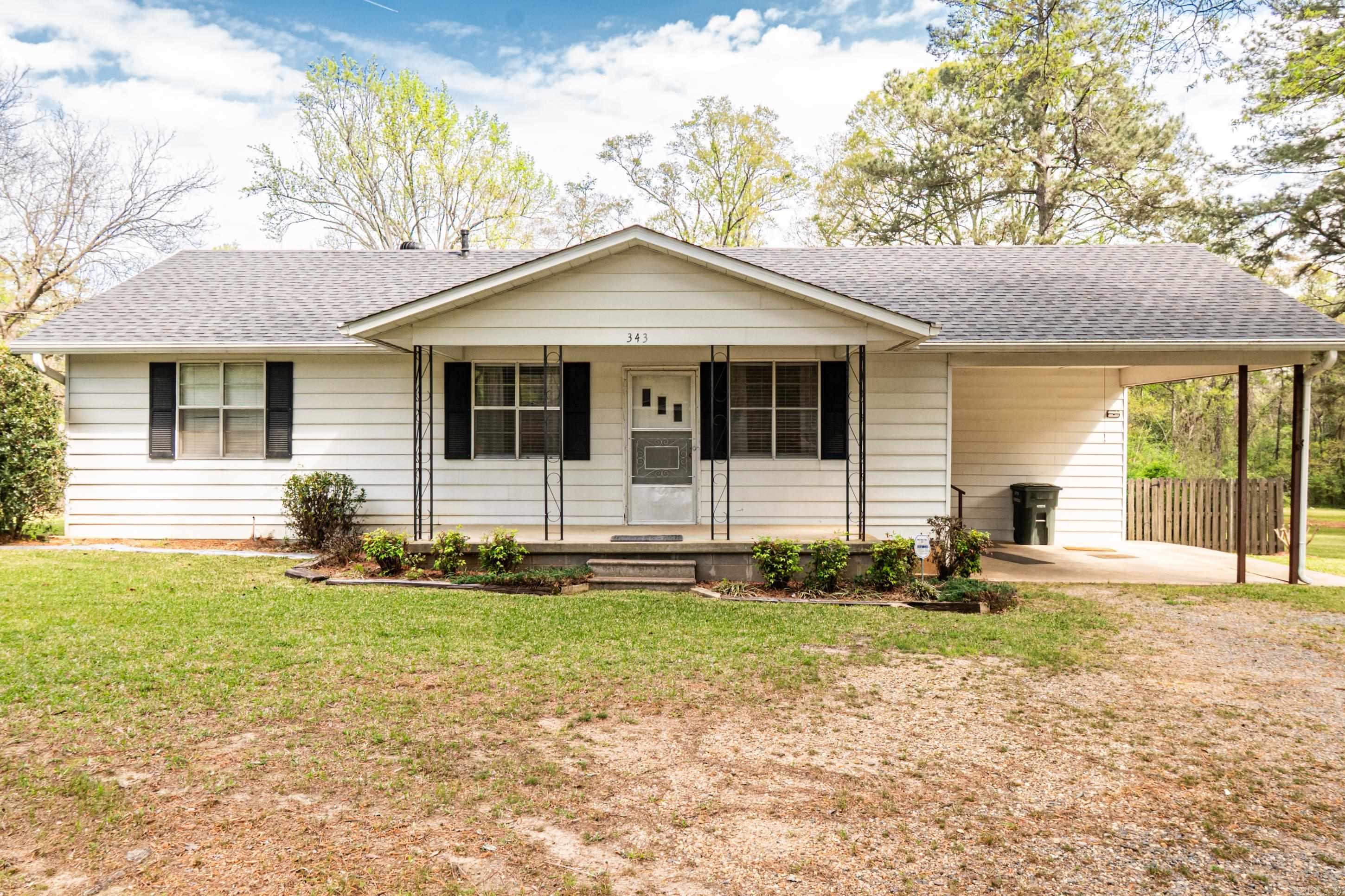 The home has a 3-year-old roof, two outbuildings, and a newer covered porch in the back. The yard is fenced and well-kept.