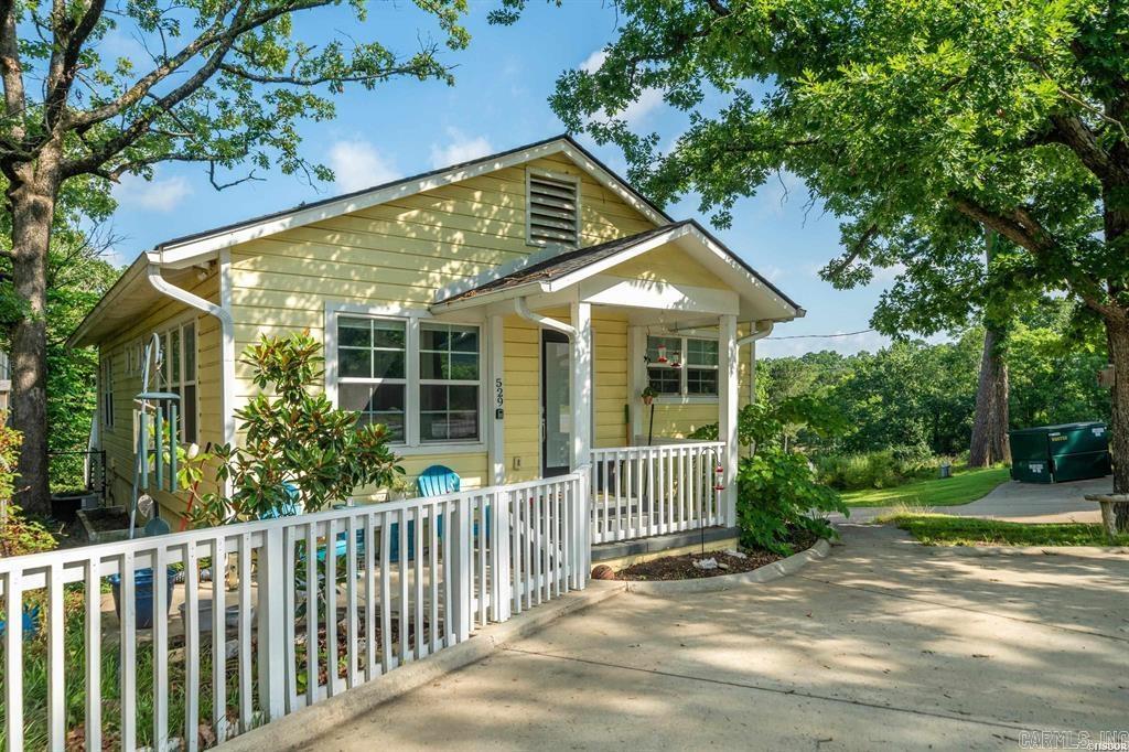 Adorable cottage with seasonal lake views, lots of natural light, and a vacation vibe. This charming retreat features a beautiful kitchen to cook all of your favorite meals and a great deck to enjoy the lush greenery of the back yard. The primary suite has a large walk-in closet and direct access to the back deck. Walk out basement with lots of potential. Easy access to everything that Hot Springs has to offer.