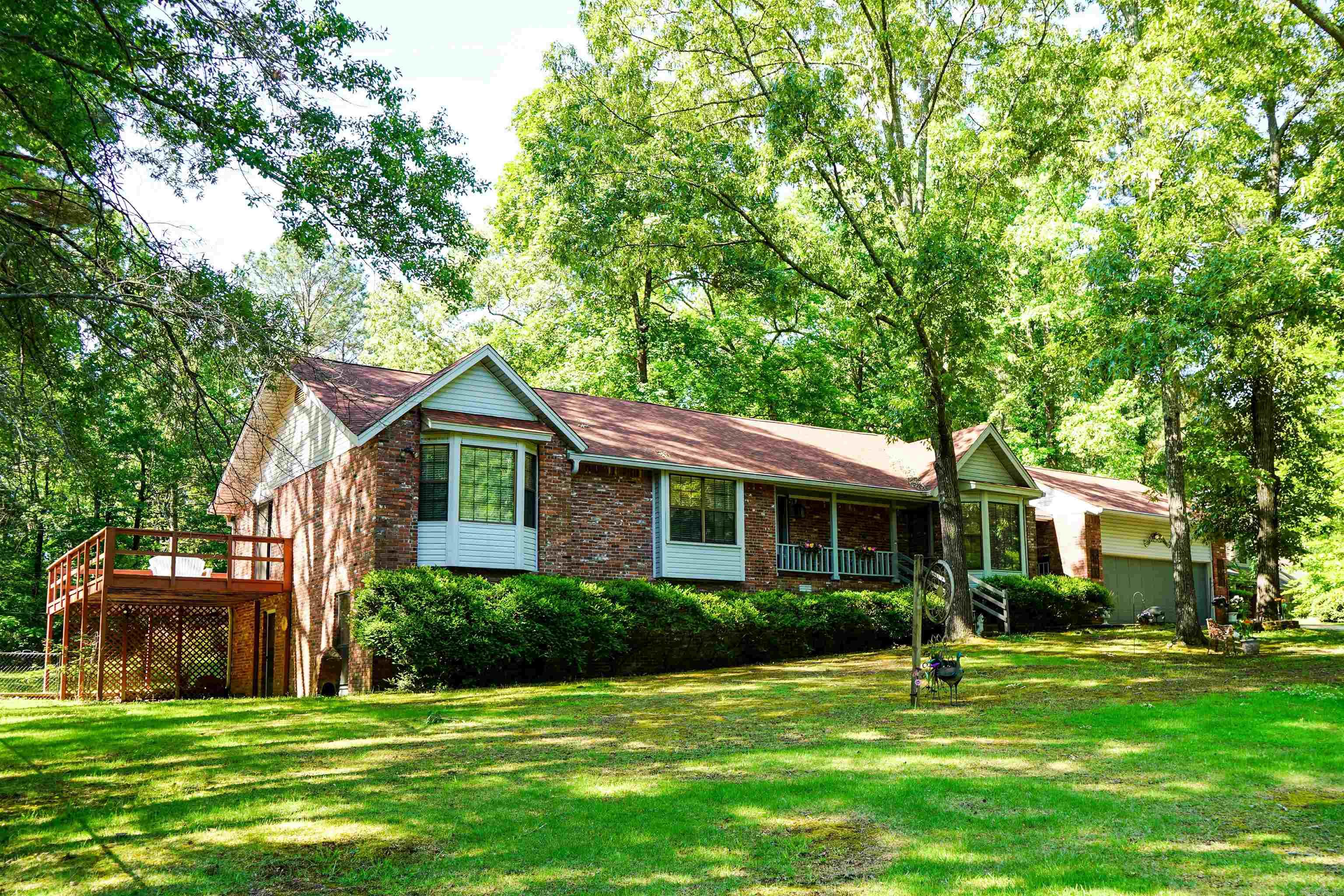 Located on a quiet cul-de-sac in Saline County, this well-maintained brick home sits on approximately 0.675 acre and offers 3 bedrooms, 2.5 baths, plus an additional shower in the oversized laundry room. The living room features vaulted ceilings, a fireplace with wood box and built in bookshelves with cabinets. The kitchen offers abundant cabinetry and bar seating for 3-4. Downstairs, the walkout basement includes a huge bonus room plus additional flex space ideal for a bedroom, office, oversized closet, or seasonal storage. Primary bedroom features French doors leading to the large wraparound porch. Enjoy outdoor living with a spacious deck and 14x14 covered area off the living room. There is a storage building in back yard. Major updates include replacement windows over the last 8 years, Trane HVAC (2021), insulated garage door (2023), covered gutters (2024), new roof (2025), luxury vinyl flooring (2021), and new septic system installed spring 2025. Great fiber internet is available through First Electric. Refrigerator, washer, dryer convey at no value. Its such a great neighborhood for walking and community living. Welcome home to 8901 Dawn Dr. You're going to love it here!!!