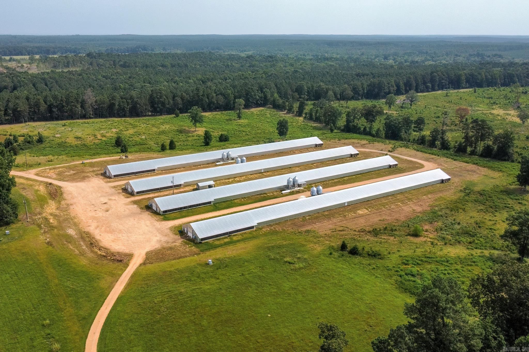 Turnkey income-producing poultry farm now available just outside of Hope, Arkansas! This fully operational farm offers an outstanding opportunity for both experienced poultry growers and those looking to expand their agricultural portfolio. Situated on approximately 29 acres, the property includes four modern broiler houses built in 2019 and is currently under contract with Tyson, providing an established income-producing operation.  The farm is well-equipped with an acre pond, three wells, an incinerator, fuel tanks, two generators for backup power, four transfer boxes, and electrical service already in place for additional building sites, giving the new owner room to expand the operation. The property's infrastructure has been designed with efficiency and long-term productivity in mind.  In addition to the poultry operation, the seller is offering the option to lease or purchase an additional 45 acres that has previously supported approximately 60 head of cattle, creating another potential source of income and making this an ideal investment for anyone interested in a diversified farming operation.