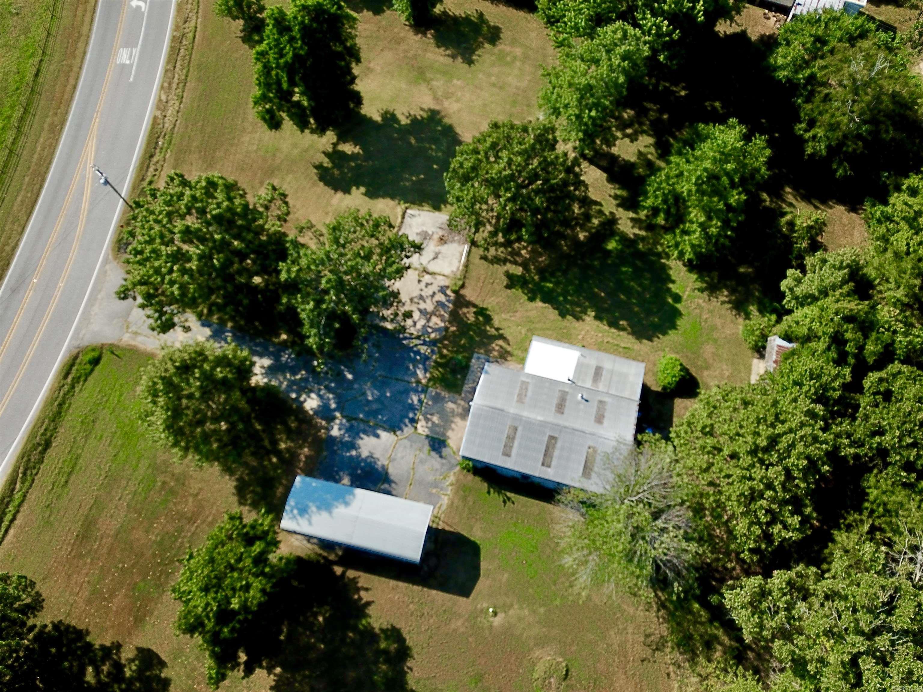 Commercial Shop w/ 4 (level) acres & Hwy 5 N and CR 11 Frontage!!! Excellent location for a business with a traffic count of 8,500 daily. 1,872 sq ft heated & insulated building. It has 11x11 office/reception with a 1/2 bath! Main part of building is 29 x 47 w/16' overhead door. Back of building has 10' sliding door and 10' roll up door, opening to a 11.5' x 15' room. Detached storage building is 16 x 24 w/ 16' roll up door, and also 19 x 24 lean-to covered storage area. RV Carport has 24 x 26 concrete pad & cover is 16 x 40 with 10' walls. MH City water, natural gas, and NEW SEPTIC in 2021. Paved drive and parking! The yard is spacious & beautiful with mature trees. Lovely options for building spots. The set-up is here to work, play & live!
