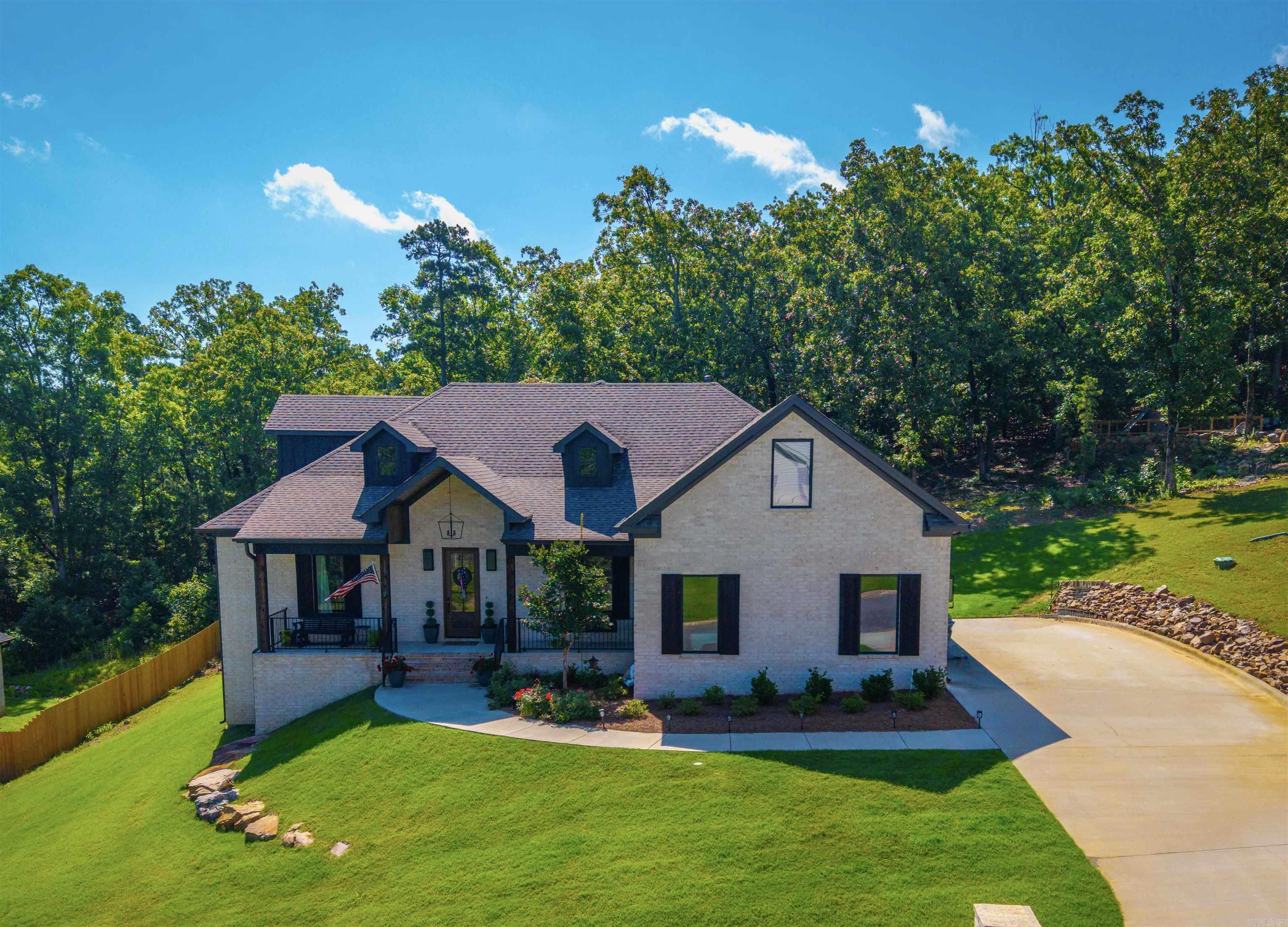 Just the right space, inside and outside in this beautiful 4-bedroom, 3-bath home!  With 3,300 square feet of thoughtfully designed space, this property backs up to peaceful woods, offering stunning views. The light brick exterior with warm wooden accents gives the home timeless curb appeal, while the spacious front porch provides an inviting spot to relax and enjoy the neighborhood atmosphere. Inside, you’ll find an open floor plan filled with natural light and a modern kitchen that’s both stylish and functional—complete with premium finishes, ample storage, and seamless flow into the living area. A bonus space upstairs offers flexibility for a game room, media room, or home office.  The primary suite is a true retreat, featuring a large walk-in shower and a soaker tub, large window and an oversized walk-in closet.   Step outside to the covered deck overlooking the wooded backdrop—a perfect setting for outdoor dining or quiet mornings with a cup of coffee. Additional features include a three-car garage and access to the many neighborhood amenities such as basketball and tennis courts, green spaces, and a GATED ENTRANCE.