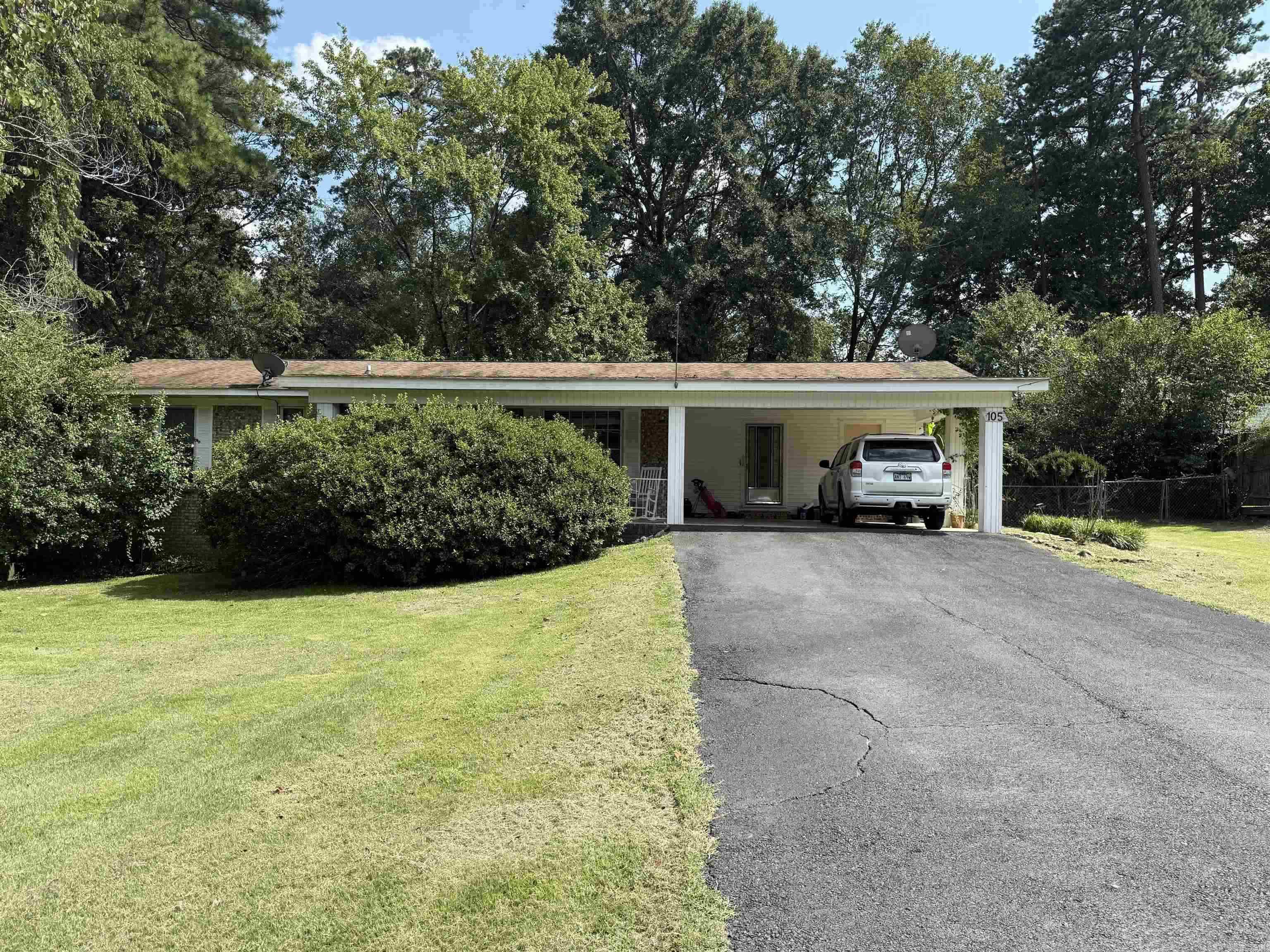 Charming all brick 3 bedroom, 2 bath home located in Lakeside School District, but outside of city limits. This property offers beautiful hardwood appearing LVP floors that add warmth and character.  A spacious double carport and oversized deck is perfect for entertaining or enjoying quiet evenings outdoors.  The large fenced backyard includes a darling barn-style 24x16 building ideal for storage, a workshop, or creative space, and it even has potential to be converted into a mother-in-law suite.  Needs some TLC
