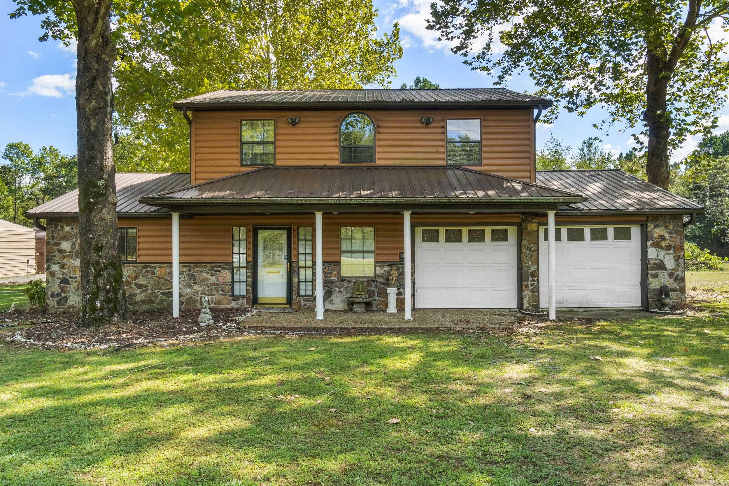 Well-maintained 4-bedroom, 2.5-bath home with a shop, ideally located just minutes from the Air Force Base and Sherwood. Situated on a spacious 1.39-acre lot (including the adjacent parcel), this property offers a unique log cabin-style exterior with plenty of room to spread out.  The detached shop provides excellent space for storage, hobbies, or a workshop setup, perfect for anyone needing extra functionality beyond the home.  Recent updates include a remodeled kitchen with new cabinets, new carpet in the living room, a recently replaced HVAC system, and updated appliances, giving buyers peace of mind on major components. The home also features a large primary suite, storm shelter, and a generously sized fenced yard ideal for pets, entertaining, or outdoor enjoyment.  With a few additional cosmetic touches, this property offers incredible potential to truly make it your own. Enjoy the blend of privacy, space, and convenience in this one-of-a-kind property!